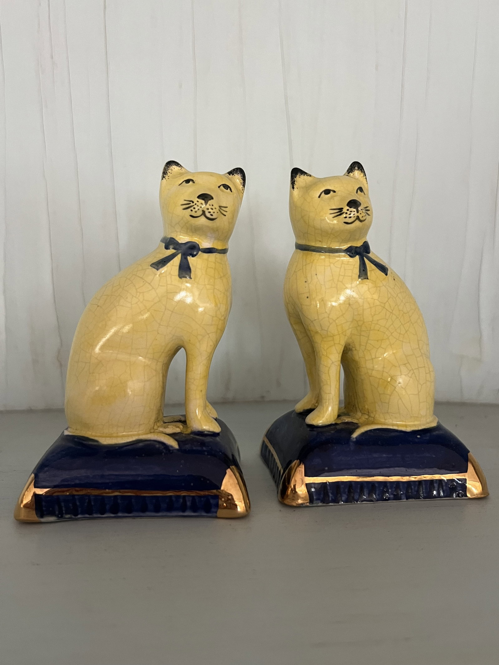 Pair of Yellow and Blue Staffordshire Cats: Small staffordshire cats, porcelain. Dimensions: H 4" x W 2.5" Condition: Some crazing. Low Estimate: 10.00 High Estimate: 10000.00