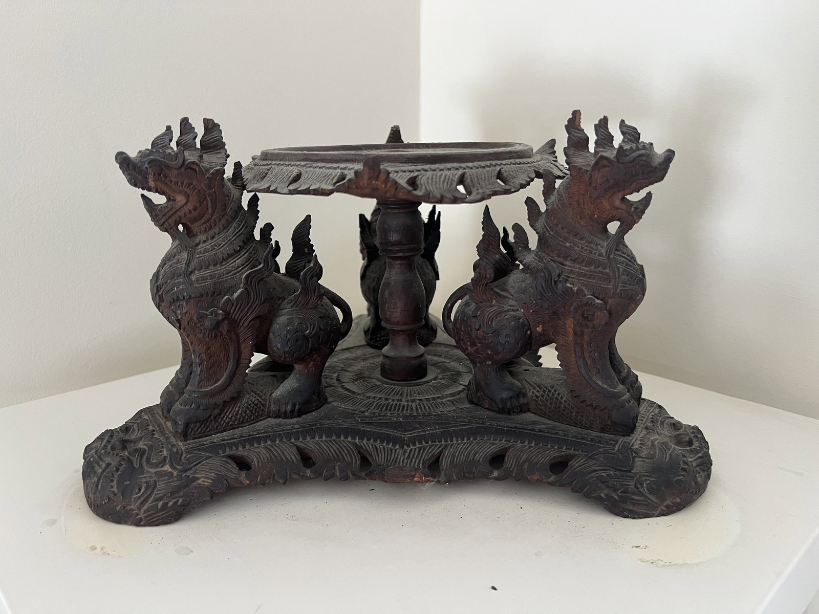 Antique 19th Century Balinese Or Myanmar State Stand: A carved wood stand with three dragons on guard. South East Asian. Dimensions: H 7" x W 12" Condition: Minor signs of use and age. Low Estimate: 10.00 High Estimate: 10000.00
