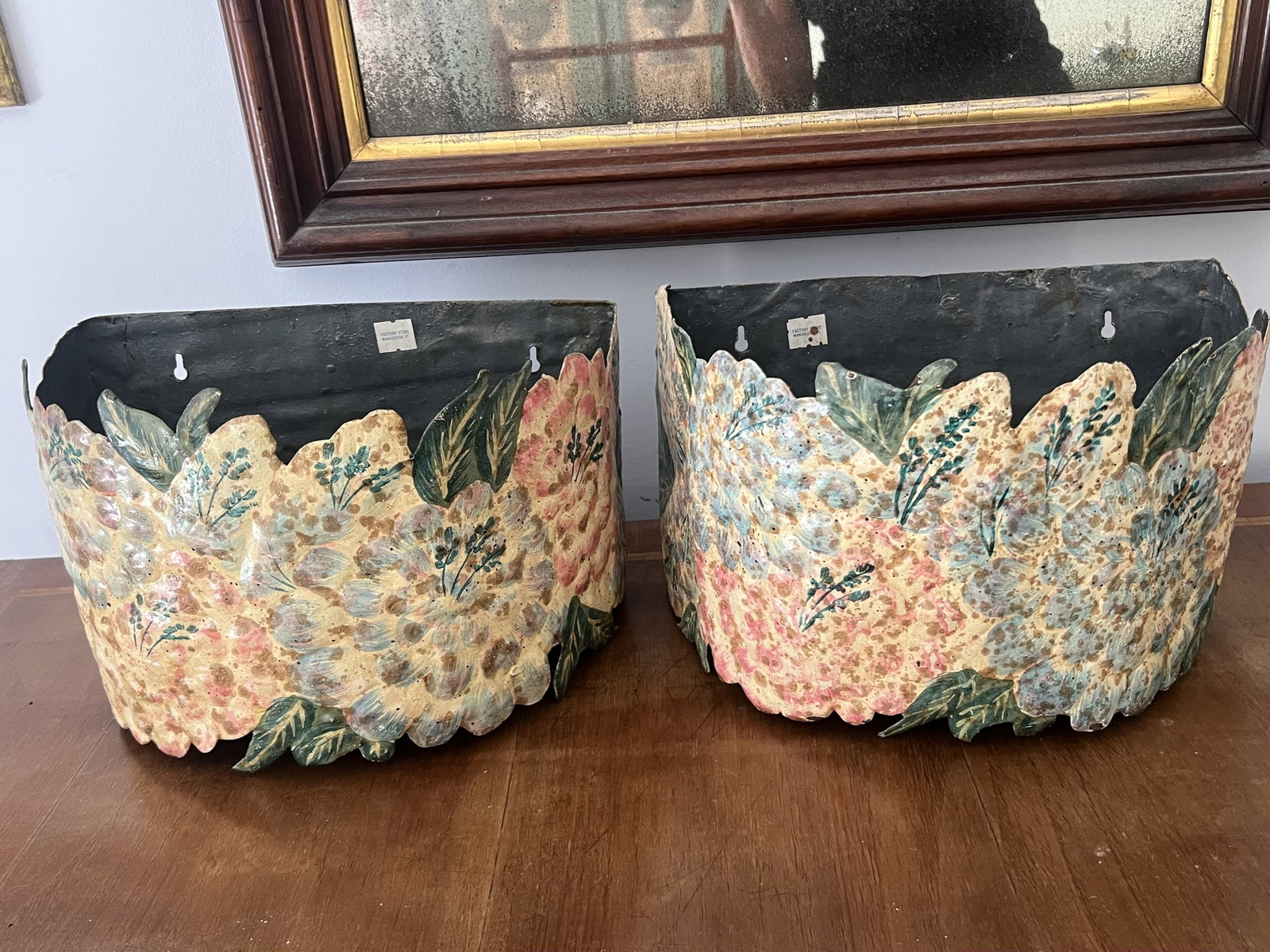 Pair of Vintage Tin Florida Wall Planters: Wall pockets or planters with floral design. Nice vintage patina. Dimensions: H 8" L 12" x W 7" Condition: Nice vintage condition. Low Estimate: 10.00 High Estimate: 10000.00