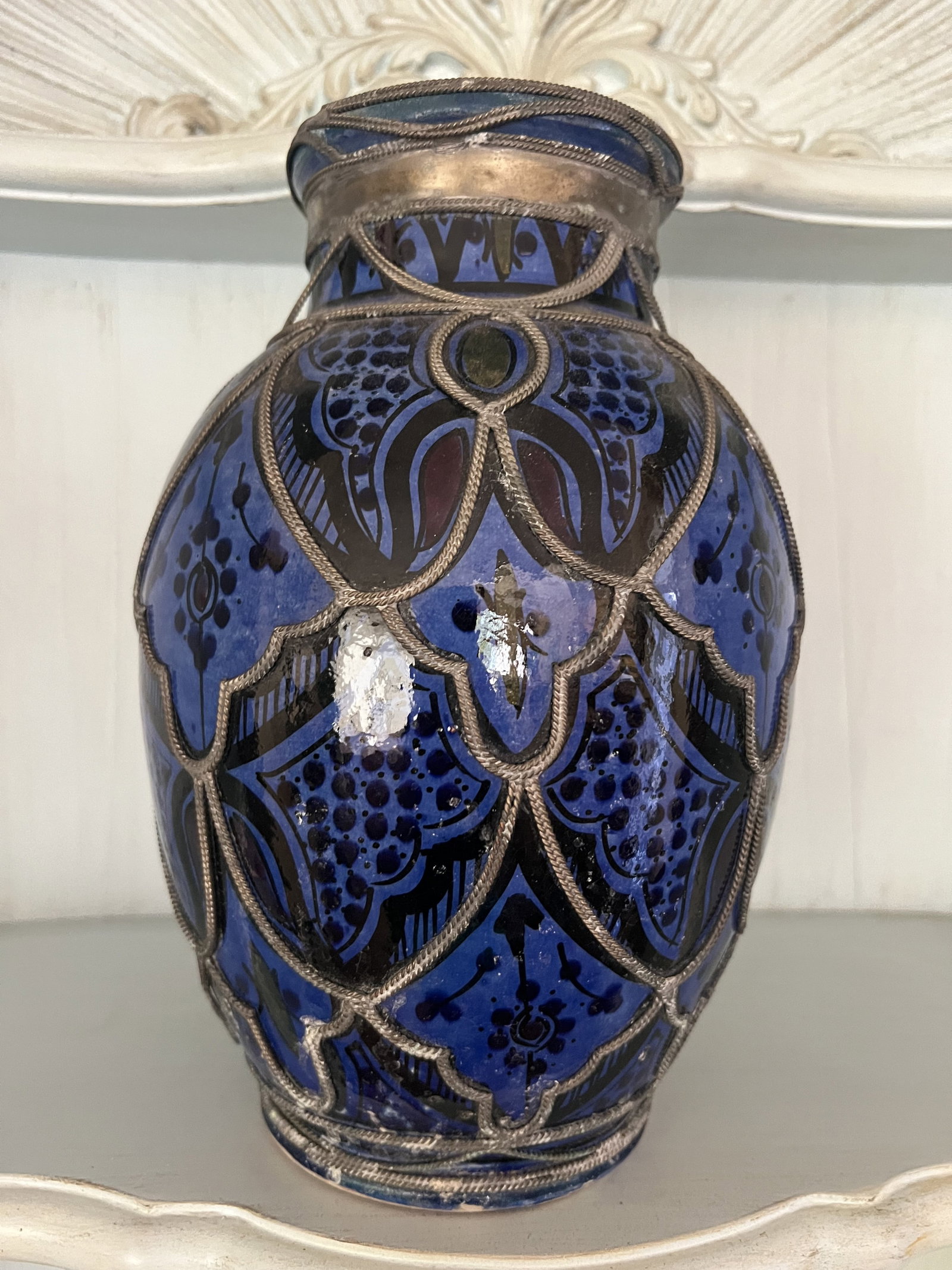 Blue Moroccan Pot: A blue glazed pottery pot with braided silver metal over. Moorish. Signed indistinctly under. Dimensions: H 11" x Dia: 9" Condition: Presenting well. Low Estimate: 10.00 High Estimate: 10000.00