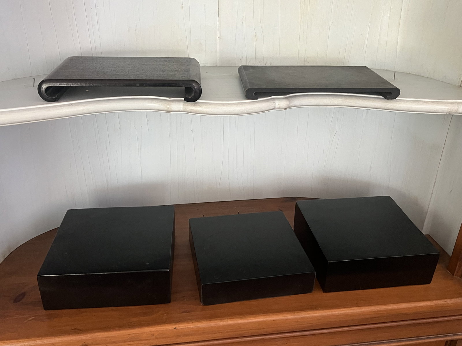 Grouping of Black Stands: Stands or risers. All black, two chinese style, two modern square. Dimensions: Largest: 8" x 3" Condition: All used. Low Estimate: 10.00 High Estimate: 10000.00