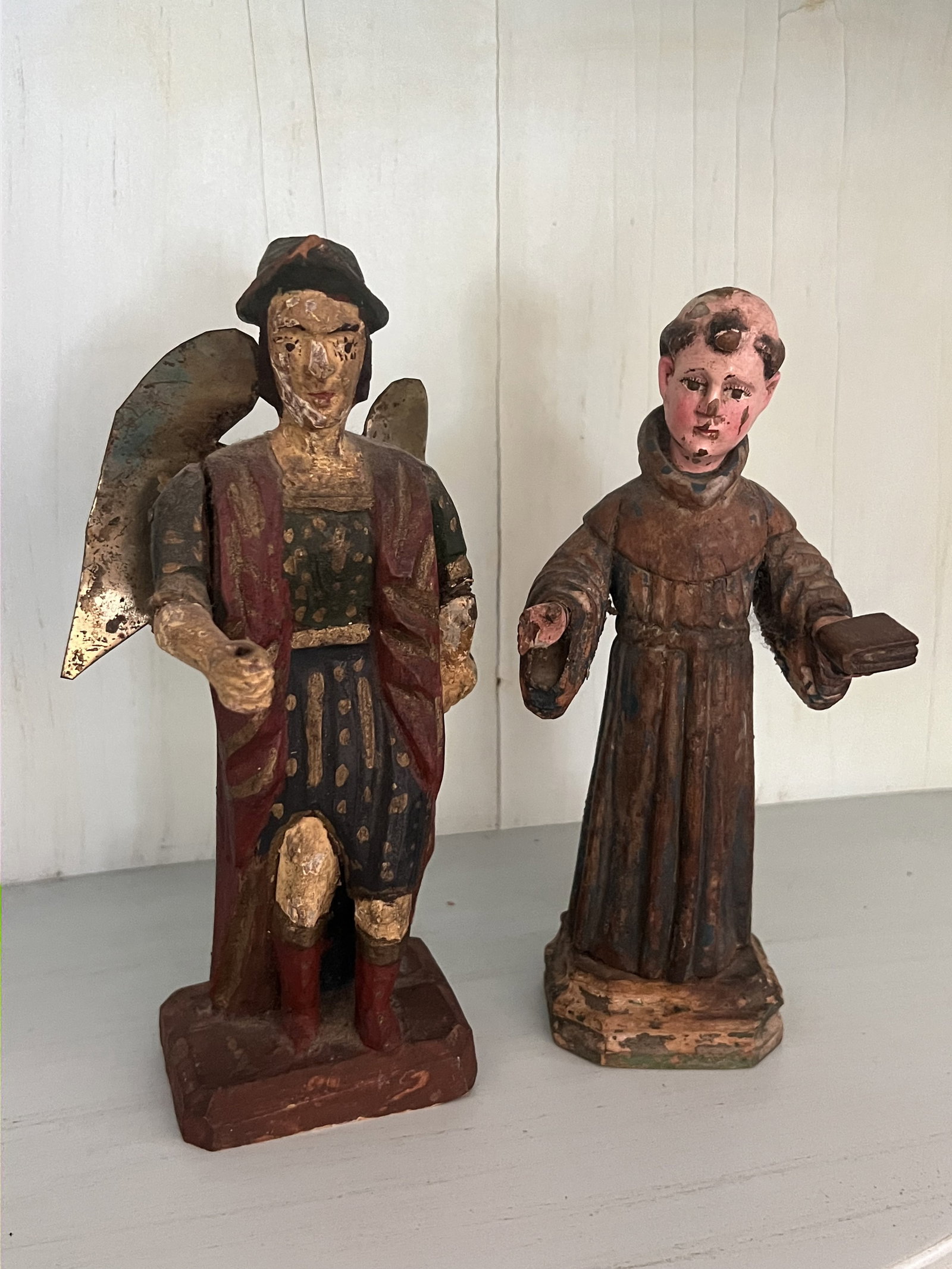 (2) Antique Spanish Colonial Carved Wooden Saint Santo: Antique Spanish carved and painted wood statues of saints. Dimensions: Larger: H 8.25" x W 3.5" x D 2.5" Condition: Signs of age including normal wear and small losses. Low Estimate: 10.00 High