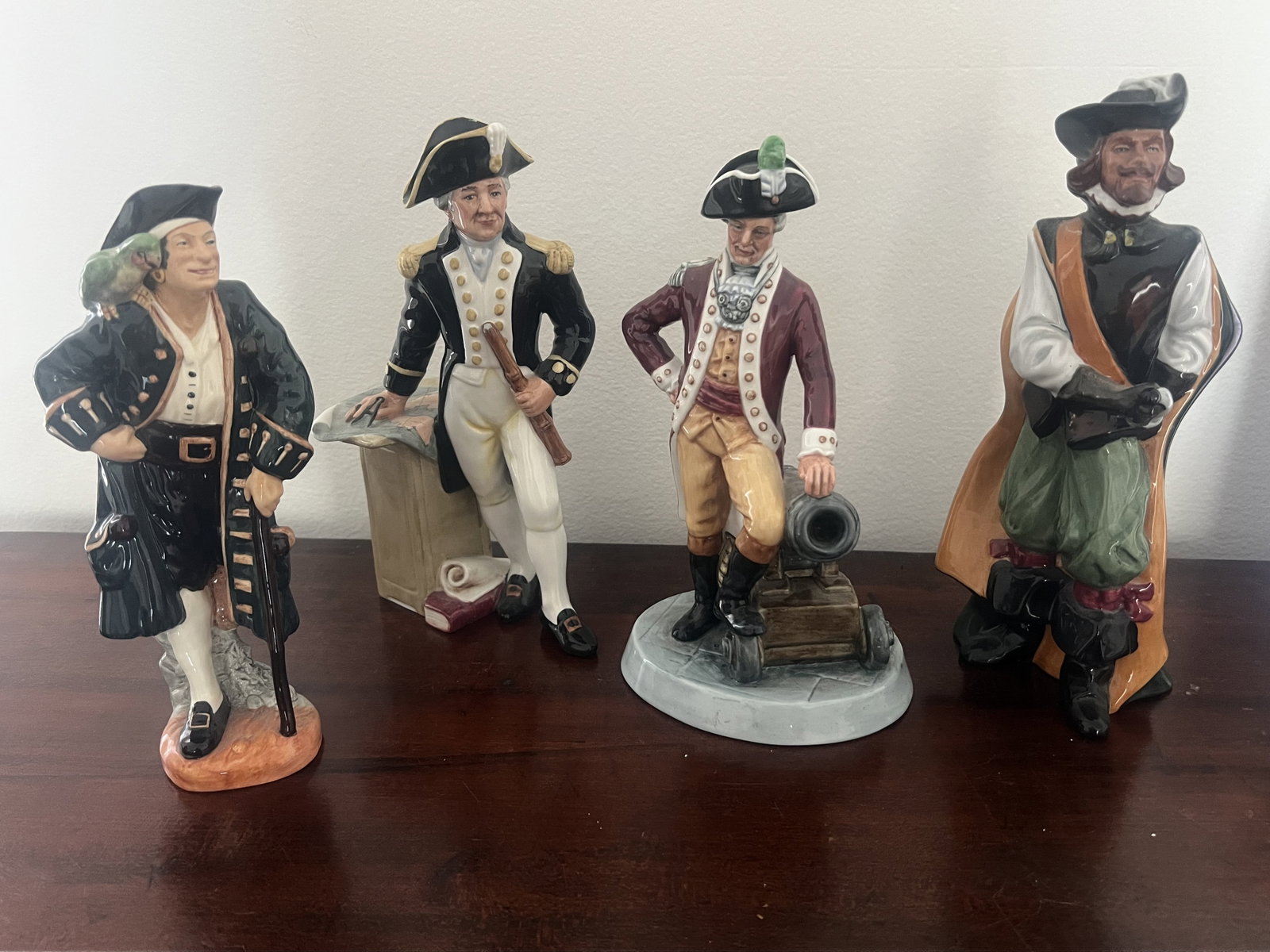 (4) Royal Doulton English Officer Figurines: Cavalier HN 2716, Officer of the Line HN 2732, The Captain HN 2250, Long John Silver HN 2204. Dimensions: Largest: H 10" x W 5" Condition: Presenting well. Low Estimate: 10.00 High Estimate: 10000.00