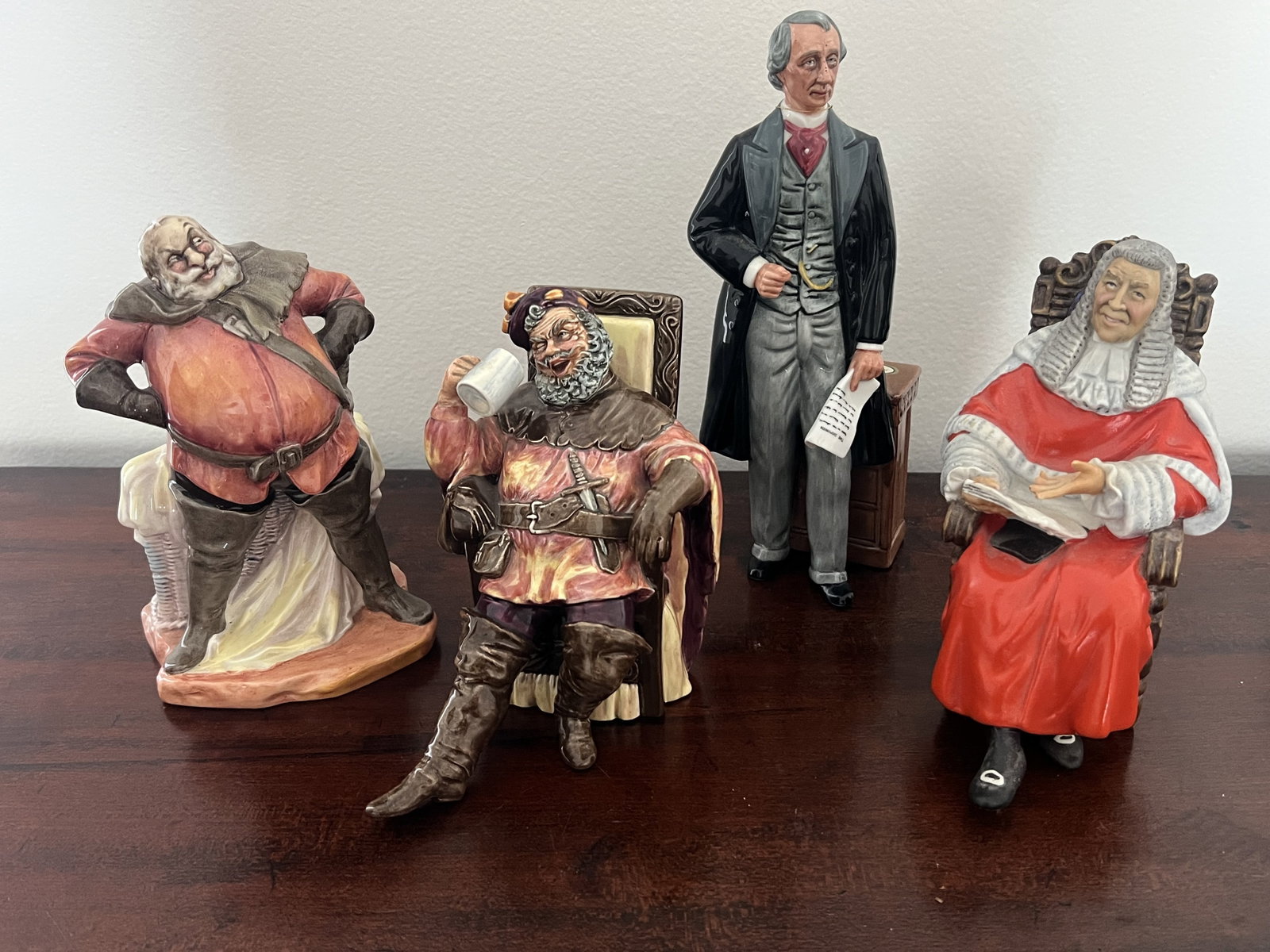 (4) Royal Doulton Man Figurines: The Judge HN 2443, Statesman HN 2859, The Foaming Quart HN 2162, Falstaff HN 2054. Dimensions: H 9" x W 4" Condition: Presenting well. Low Estimate: 10.00 High Estimate: 10000.00