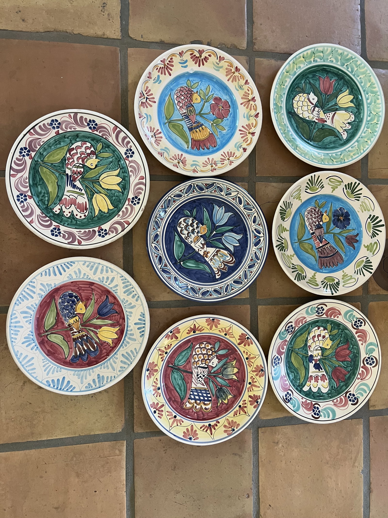 (8) Lamas Italy Terra Cotta Plates with Birds: 12" diameter dinner plates. Some with markers marks to backs, somet without. A few small chips. Low Estimate: 10 High Estimate: 10000