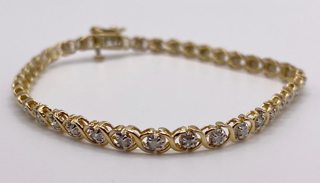 10K GOLD AND DIAMOND TENNIS BRACELET WITH RECENT APPRAISAL: 10K yellow gold and diamond tennis bracelet. It features 39 genuine, round full cut diamonds. The diamonds have a total weight of 0.75 carats. The diamonds are alike in color, “H” with no visi