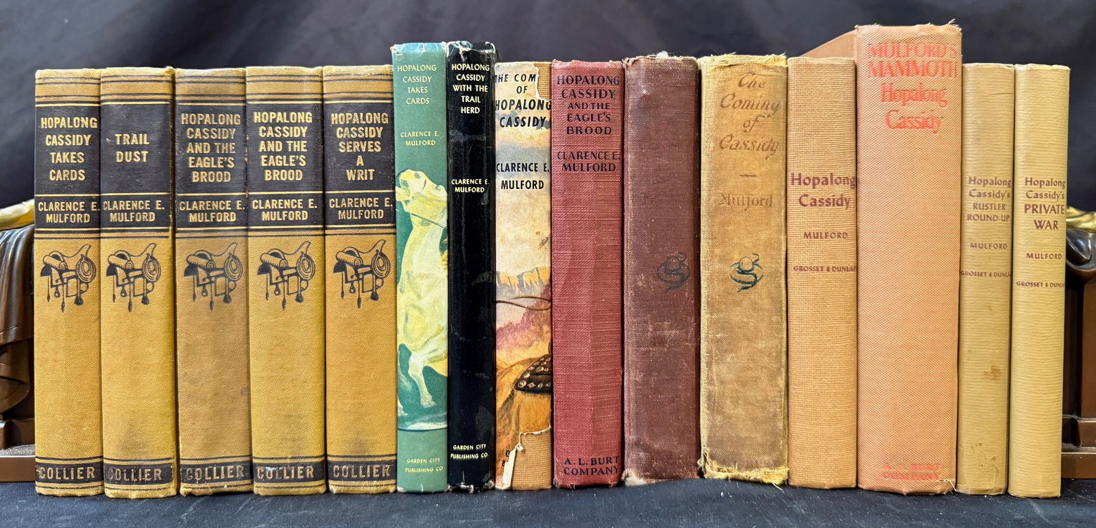 HOP-A-LONG CASSIDY BOOK SET, 15 VOLUMES, 1907-1941: 1907-1941. A set of books by 6 different publishers about the fictional cowboy named Hop-a-Long Cassidy who was a character created by Clarence E. Mulford. All volumes in Very Good+ to Very Good condi
