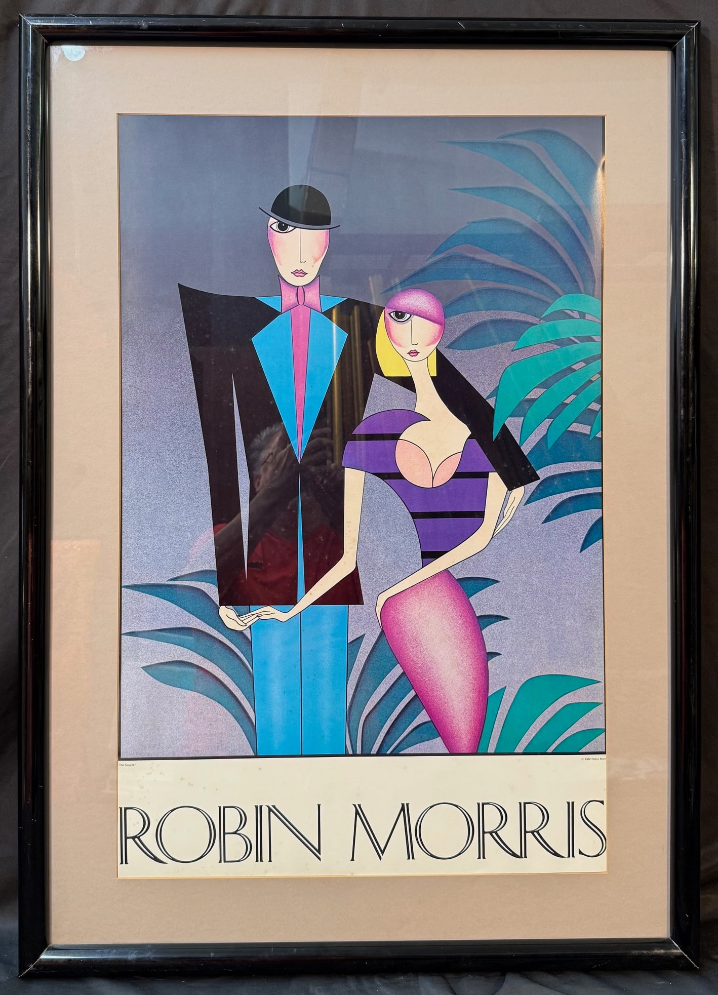 ROBIN MORRIS (1953) LITHOGRAPH TITLED THE COUPLE, 28IN x 39IN (71cm x 99cm): Robin Morris (1953) lithograph titled The Couple. This piece was produced in 1982 and it was the first work of art that brought fame to the artist. This piece is matted and framed under acrylic. With