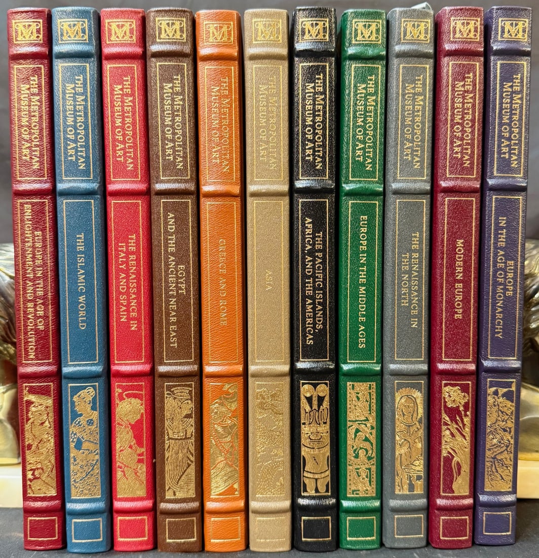 THE METROPOLITAN MUSEUM OF ART, DECORATIVE LEATHER-BOUND ART HISTORY BOOK SET (11 VOLS.): An attractive matching set of art history volumes published by The Metropolitan Museum of Art (New York) by The Franklin Library. Uniform leather bindings with gilt spine titling and decorative pictor