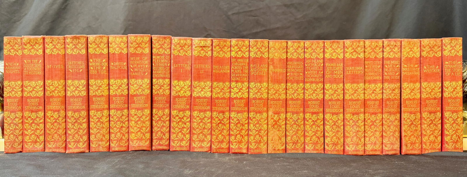 THE TRAVELS AND ESSAYS OF ROBERT LOUIS STEVENSON, 23 VOLUMES, 1903: New York. 1903. Published by Charles Scribner’s Sons. Complete in 26 volumes, missing 3 volumes. All volumes are in Very Good+ to Very Good condition. All bound in red cloth hard cover. Gold embossi