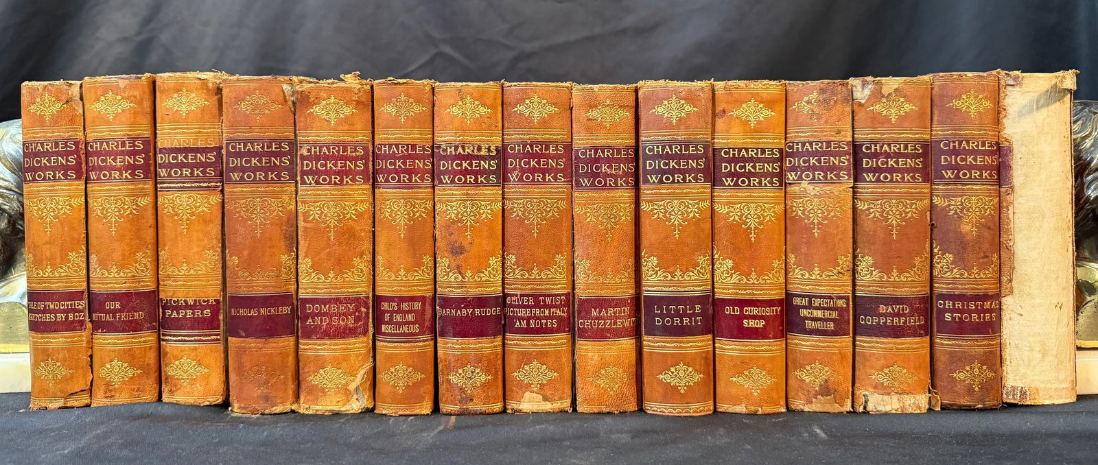 CHARLES DICKENS WORKS, 15 VOLUMES, 1901: Chicago-New York. 1901. Donahue Brothers, Publishers. 19 Stories in 15 volumes. All volumes in Very Good to Good condition, and bound in half tan leather hardcovers with marbled boards, and embossed o