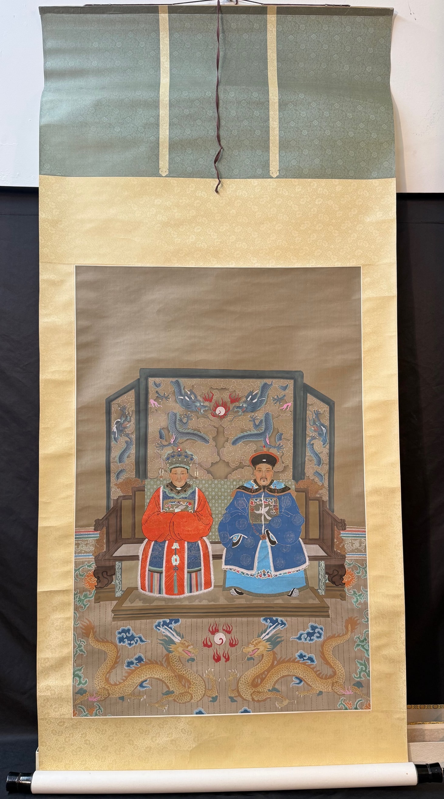 ANTIQUE IMPERIAL ANCESTOR PORTRAIT OF AN EMPEROR AND EMPRESS, 31IN x 74IN (79cm x 188cm): A finely executed Chinese imperial ancestor portrait depicting an emperor and empress seated together in formal court attire, rendered in ink and mineral pigments on silk and mounted as a traditional