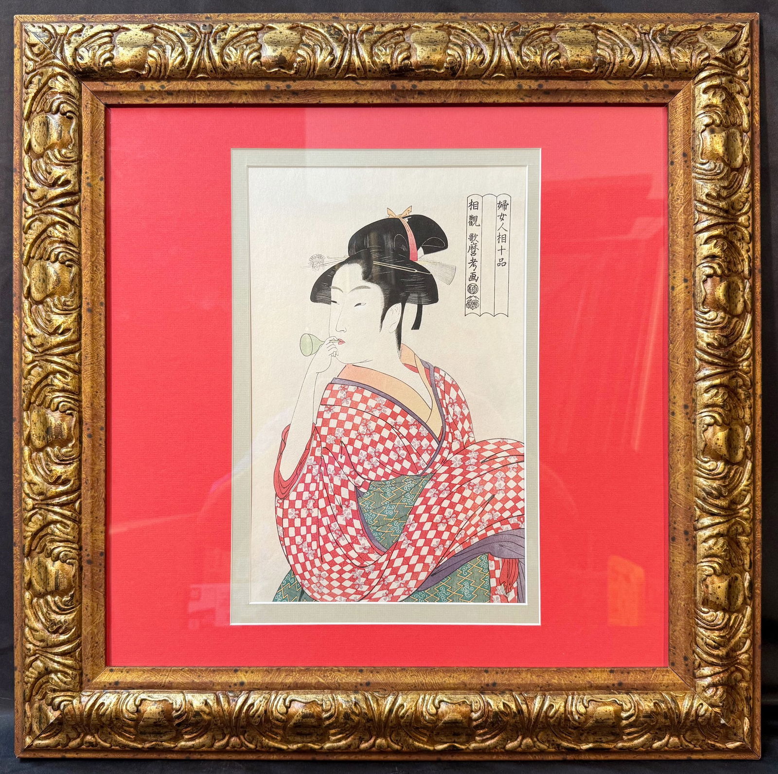 ANTIQUE JAPANESE WOODBLOCK PRINT BY KITAGAWA UTAMARO (1753-1806) TITLED YOUNG WOMAN BLOWING A POPPIN: Antique Japanese woodblock print by Kitigawa Utamaro (1750-1806) titled Young Woman Blowing a Poppin. This piece is after the original which was created in 1792. There is a seal in the lower left marg