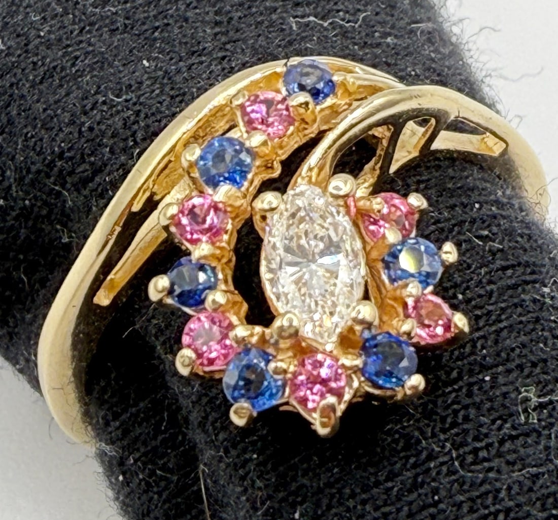 14K MARQUISE DIAMOND WITH SAPPHIRES AND PINK TOURMALINES AND RECENT APPRAISAL: One 14k yellow gold marquise cut diamond with sapphires and pink tourmaline ring. Mounted in the center of this ring is one marquise cut diamond. This diamond has an approximate weight of .20cts, colo