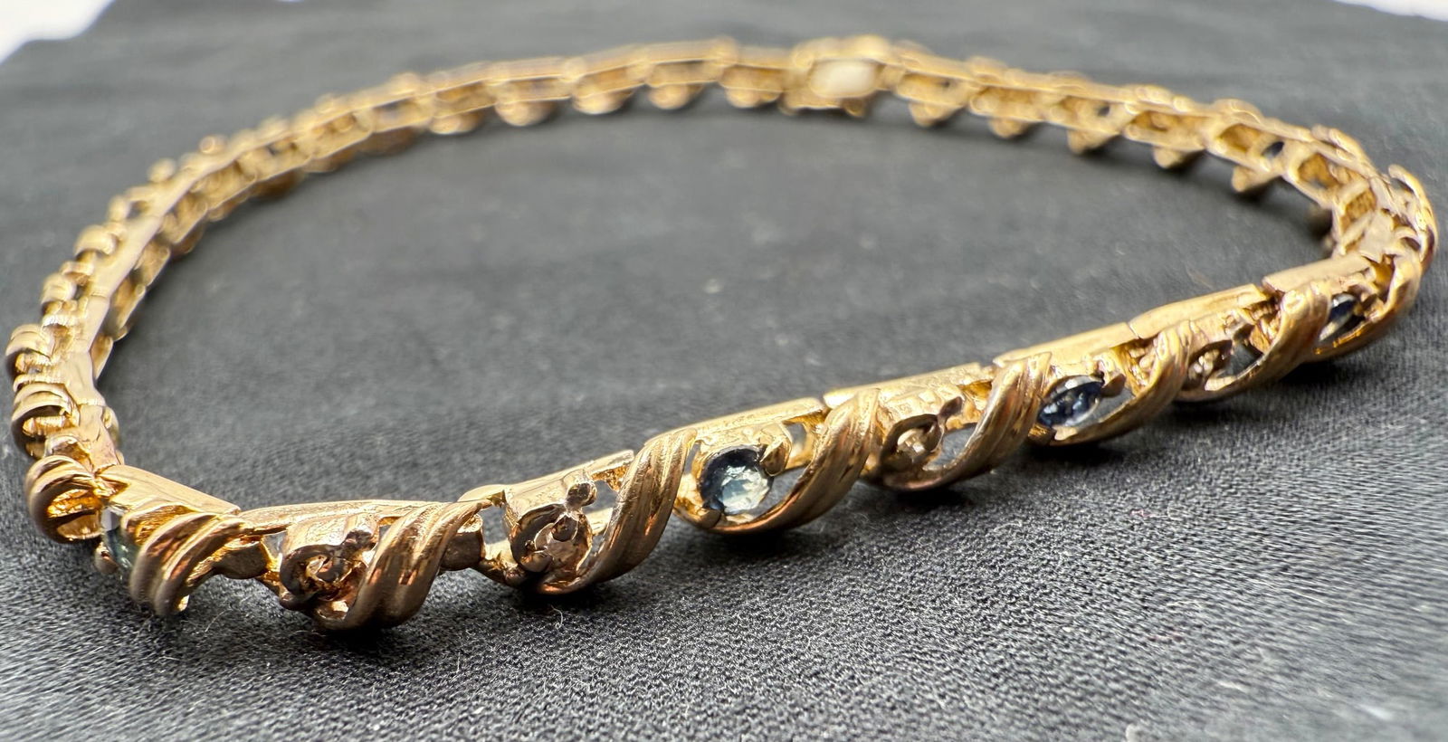 10K YELLOW GOLD, SAPPHIRE AND DIAMOND BRACELET: One 10k yellow gold alternating sapphire and diamond bracelet. Mounted in this bracelet are fifteen round cut sapphires and sixteen single cut melee diamonds. The sapphires are A in quality and have a
