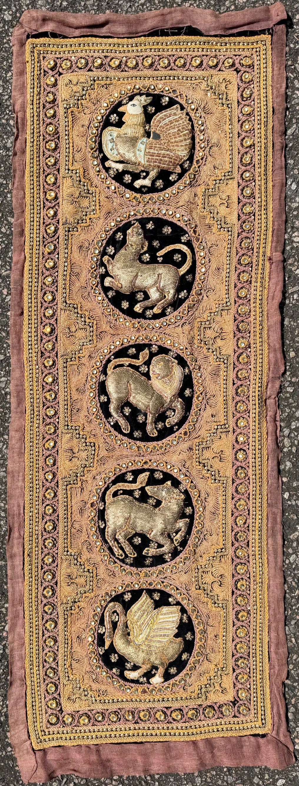 VINTAGE BURMESE KALAGA THAI NEEDLEWORK EBROIDERY WITH FIVE ZODIAC SIGNS, 18IN x 49IN (46cm x 124cm): Very elaborate, hand-stitched embroidery work using brass sequins, glass beads, golden wound cotton cords of yellow, beige, brown, orange and grey on a black velvet background. The animal figures are