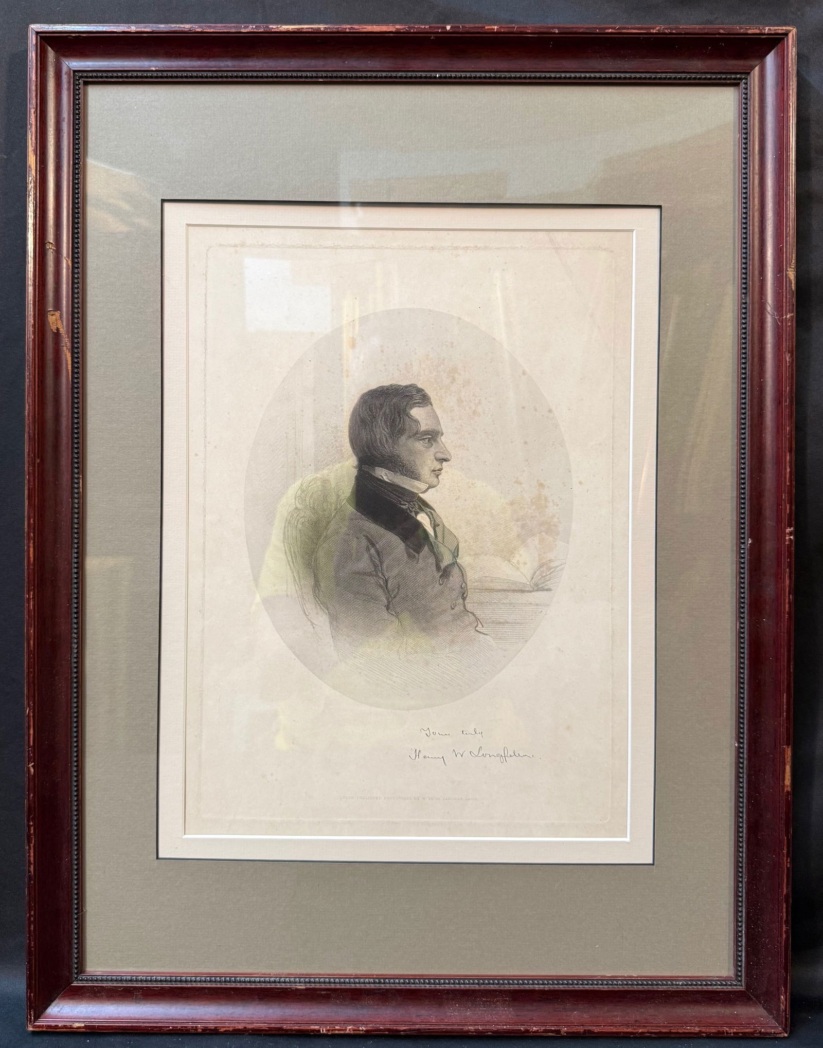 PORTRAIT ENGRAVING OF HENRY WADSWORTH LONGFELLOW, 1860s, 18IN x 24IN (46cm x 61cm): A finely engraved nineteenth-century portrait of the celebrated American poet Henry Wadsworth Longfellow, shown seated in profile beside a writing table with an open book—an emblematic pose emphasiz