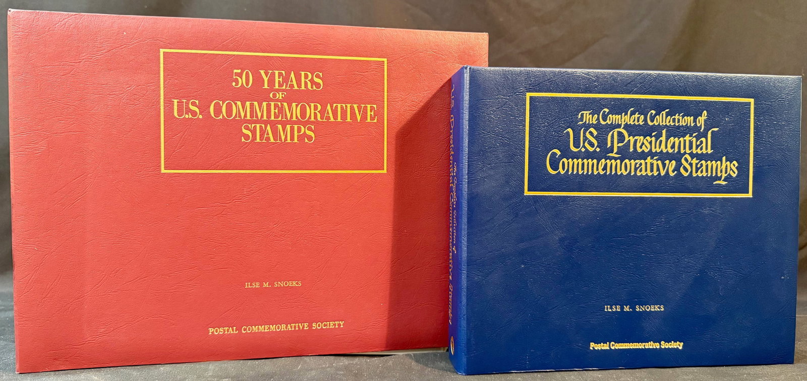 TWO COLLECTIONS OF U.S. POSTAL SERVICE COMMEMORATIVE STAMPS: BOOK 1: Postal Commemorative Society 50 Years of U.S. Commemorative Stamps album. Huge stamp album featuring U.S. stamps from various years. These stamps are all unused and set inside plastic holders