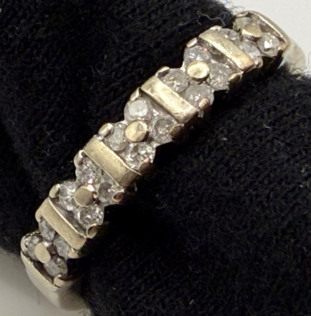10K WHITE GOLD DIAMOND BAND AND RECENT APPRAISAL: One 10k white gold diamond band. Mounted in this band are twenty round cut diamonds that are prong set in groups of four. These diamonds have an approximate total diamond weight of 20cts, color I, and
