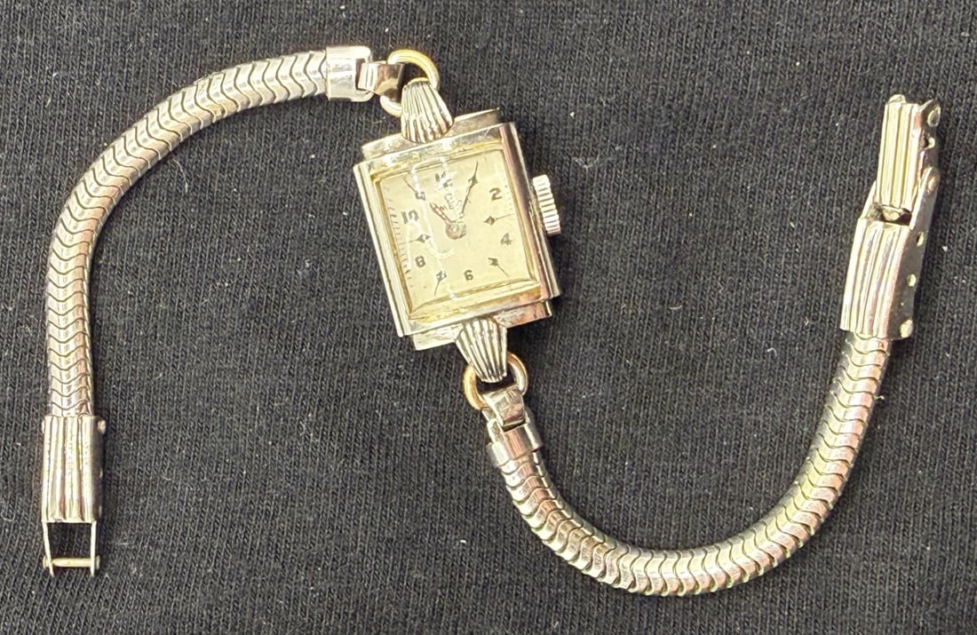 VINTAGE LADIES OMEGA SWISS WRISTWATCH WITH KREISLER GOLD FILLED BRACELET, CIRCA 1940s: Elegant vintage ladies wristwatch by Omega, dating to approximately the late 1930s–1940s, featuring a rectangular Art Deco–era case paired with a period American-made bracelet. The watch is fitted