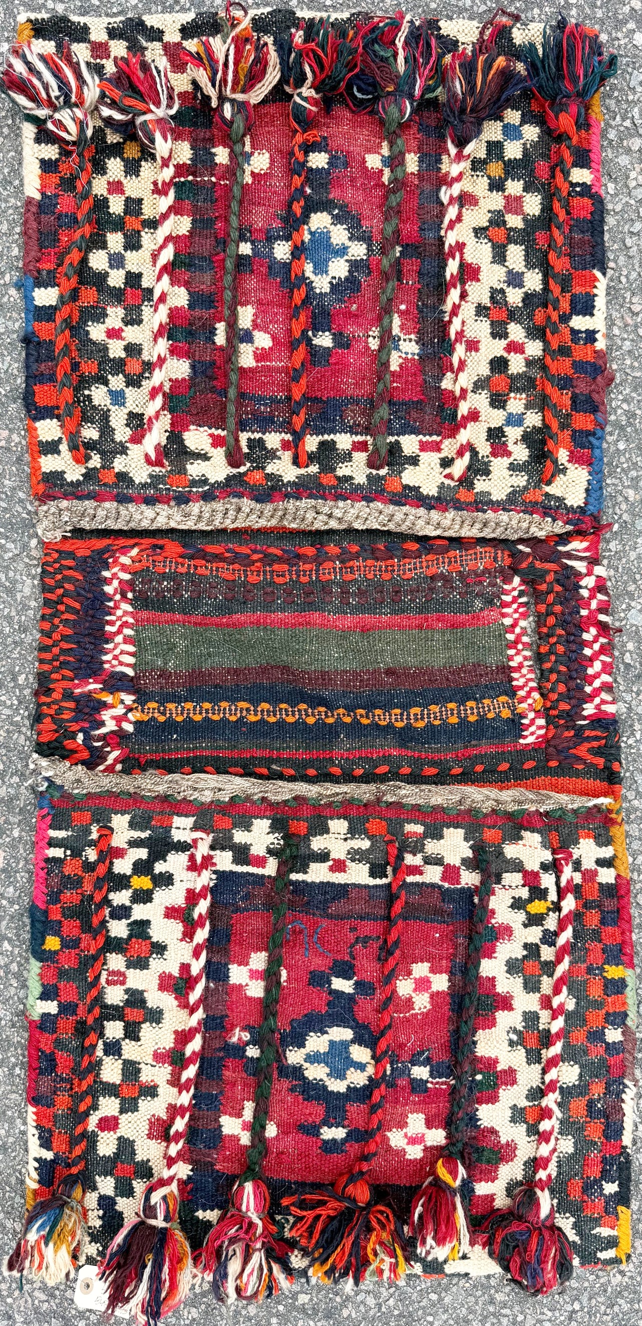 HIGHLY DECORATED PERSIAN TRIBAL SADDLE BAG (KHORJIN), QASHQAI POLYCHROME WOOL, TASSELS & BRAIDED: Offered here is an authentic Persian tribal saddle bag or “khorjin”. This saddle bag is handwoven in wool by nomadic weavers of the Qashqai tribal tradition. This exceptionally vibrant and hig