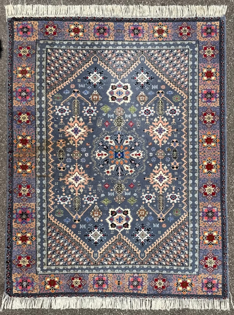 MOROCCAN RABAT HAND KNOTTED RUG, 5.10 x 7.10 (178cm x 239cm): An exceptional hand-knotted Moroccan rug featuring an unusually refined blue-grey field framed by richly saturated jewel-tone borders executed in crimson, ivory, coral, sapphire, violet, and black. Un