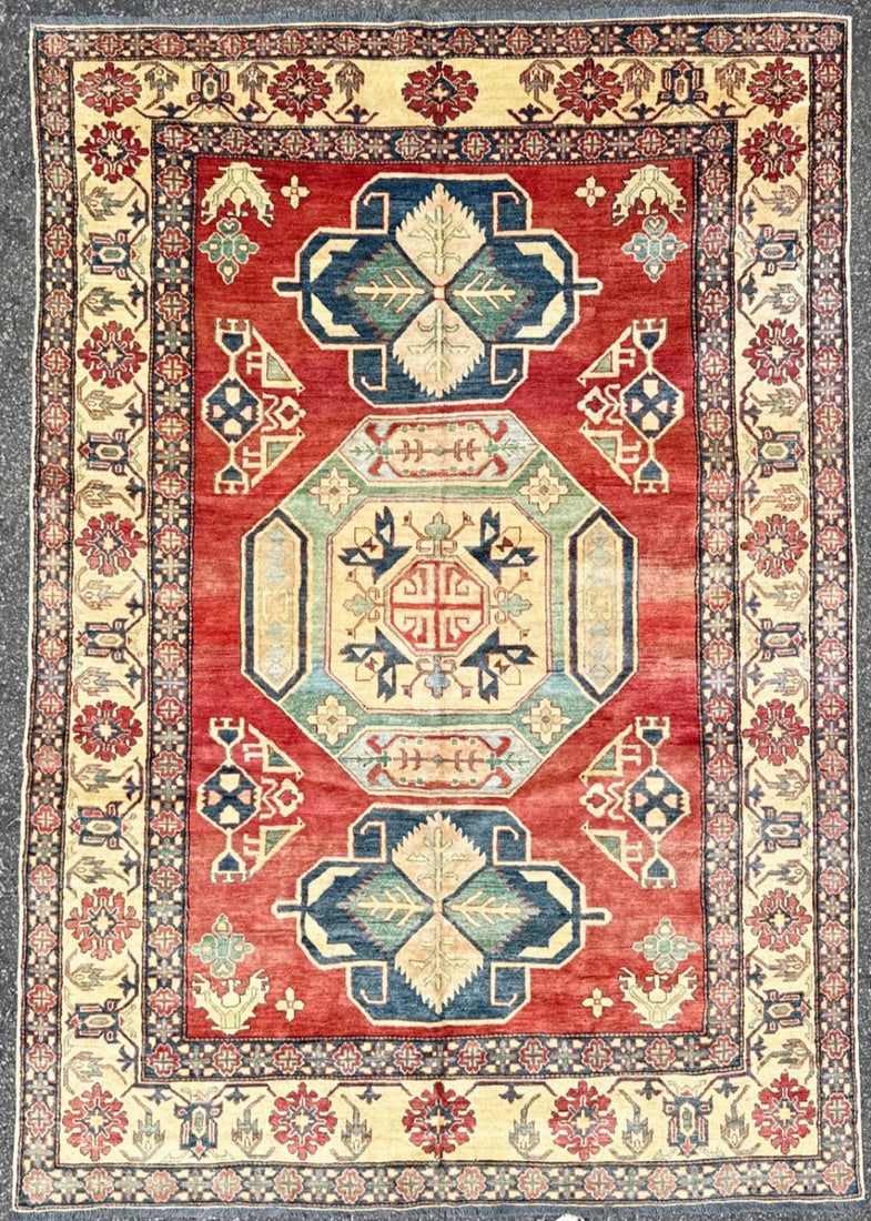 CAUCASIAN KAZAK HAND KNOTTED RUG, 6.10 x 9.11 (208cm x 302cm): This hand-knotted Caucasian Kazak rug was made in Turkey and it delivers exactly what serious interiors demand: presence, structure, and unmistakable character. The saturated madder red field sets the