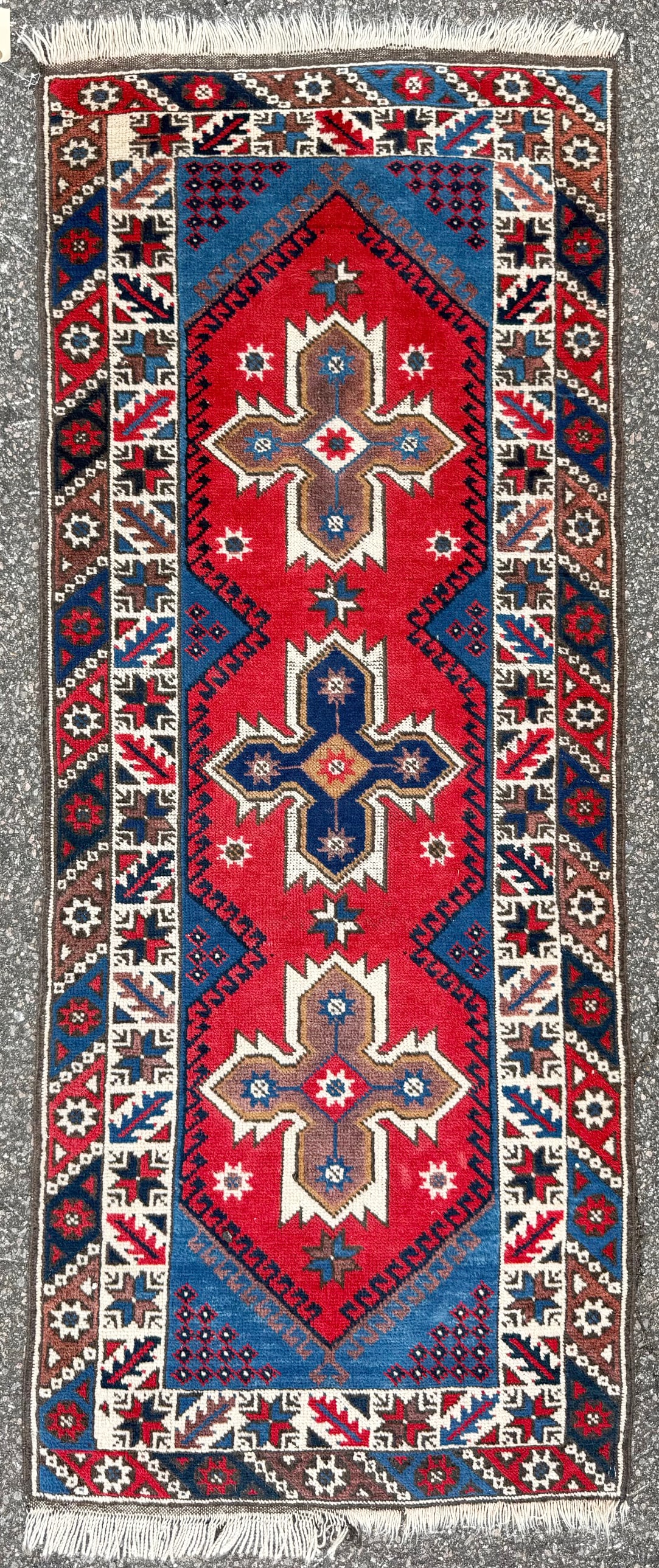 VINTAGE PERSIAN KAZAK CAUCASIAN HAND KNOTTED RUG, 2.5 x 6.2 (74cm x 188cm): This Vintage Caucasian Kazak rug was hand knotted in Persia (Iran) of 100% natural wool on a cotton foundation. The rug is 50+ years old and displays a striking three-medallion composition, with large