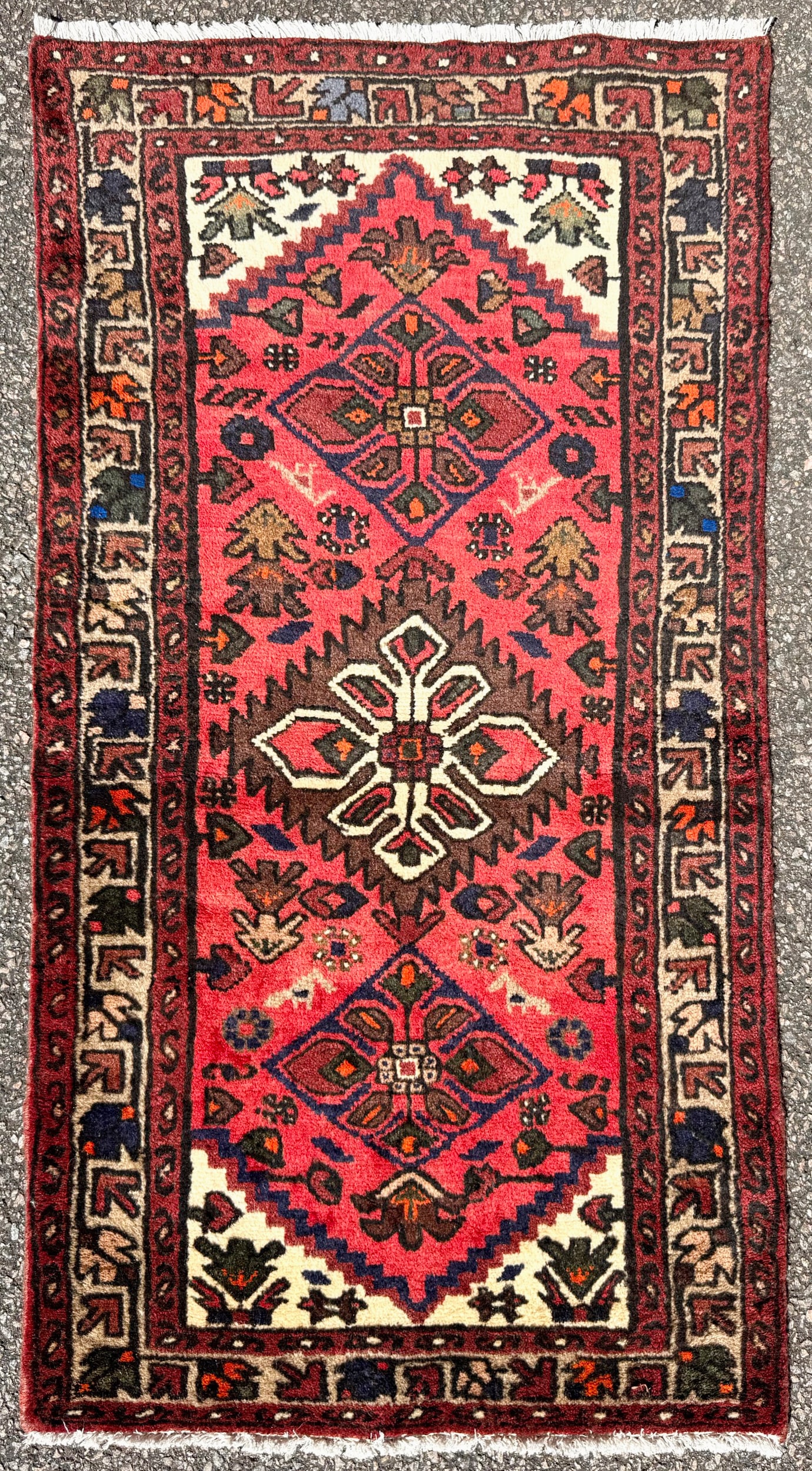 VIBRANT PERSIAN HAMADAN TRIBAL RUG, TRIPLE MEDALLION, IVORY BORDER, HAND KNOTTED, 2.2 x 4.2 (66cm x: A visually striking and highly decorative hand-knotted Persian Hamadan rug distinguished by its bold triple medallion composition set against an unusually vibrant red field, framed by a crisp ivory-gr