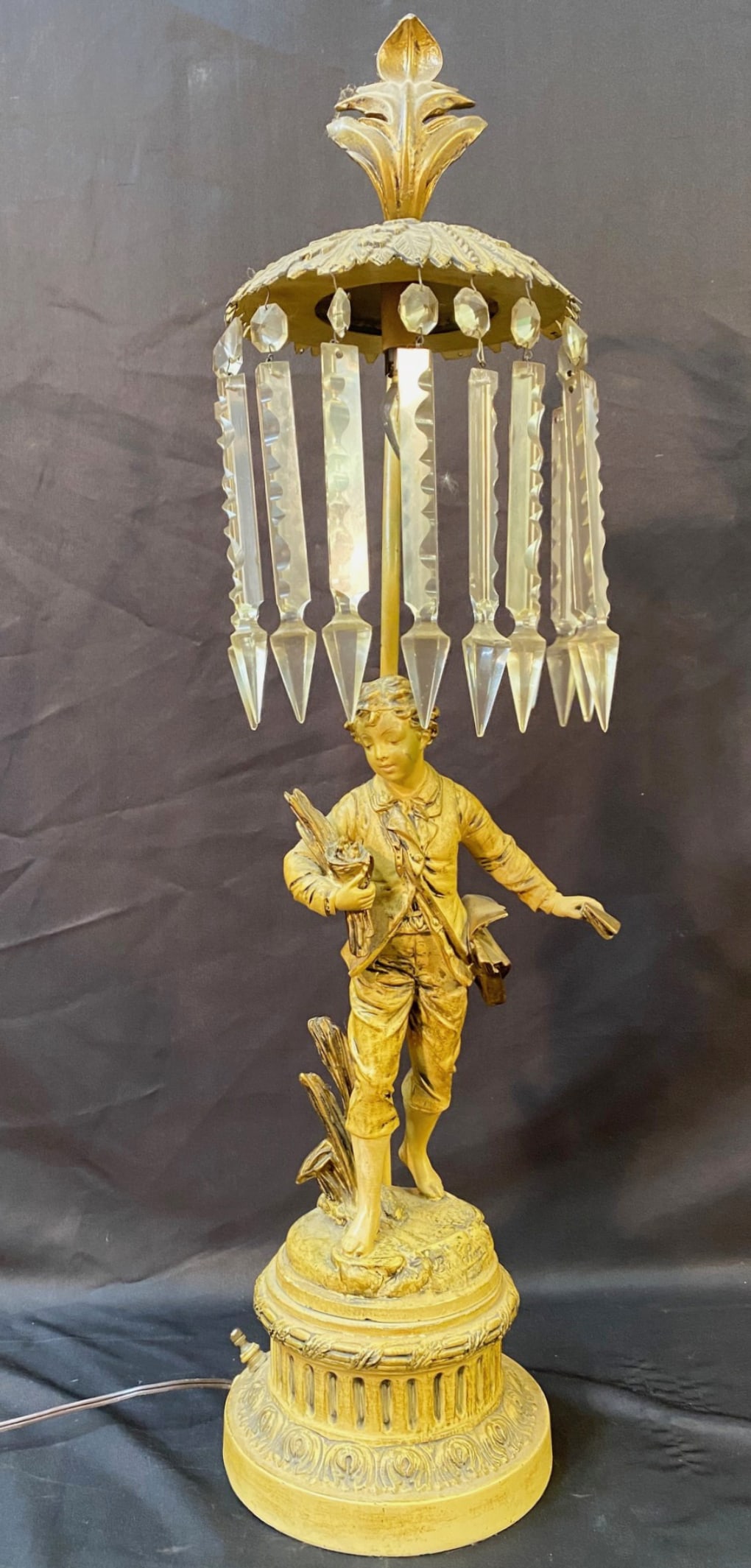 ANTIQUE EMILE BRUCHON (1806-1895) BOY GILT BRONZED CRYSTAL FRENCH LOUIS XIV LAMP, 30.5IN TALL: Emile Bruchon (1806-1895) gilt bronze, Louis XIV lamp showing a boy walking. The lamp is in working order, and there are 10 crystals that are dangling from the lamp. The antique lamp is 30.5 inches ta