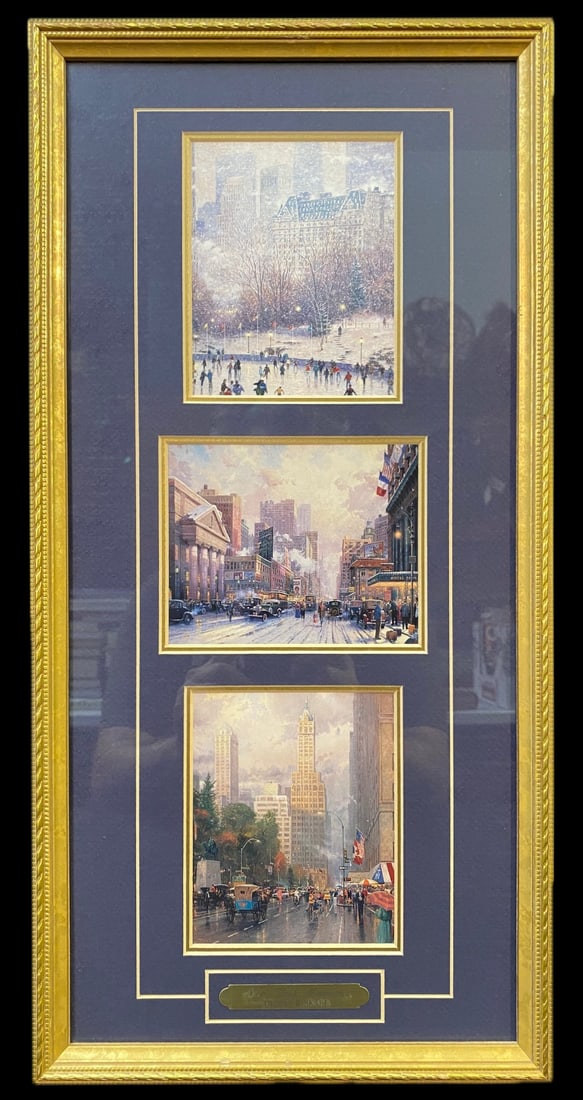THOMAS KINKADE (1958-2012) LIMITED EDITION, SIGNED LANDSCAPE TRIPLE PRINTS WITH COA TITLED NEW YORK: Limited edition, signed landscape triple prints by Thomas Kinkade (1958-2012). It is titled New York Memories and it measures 10 in x 21 in. It was produced in 1997. It is double matted and framed in 