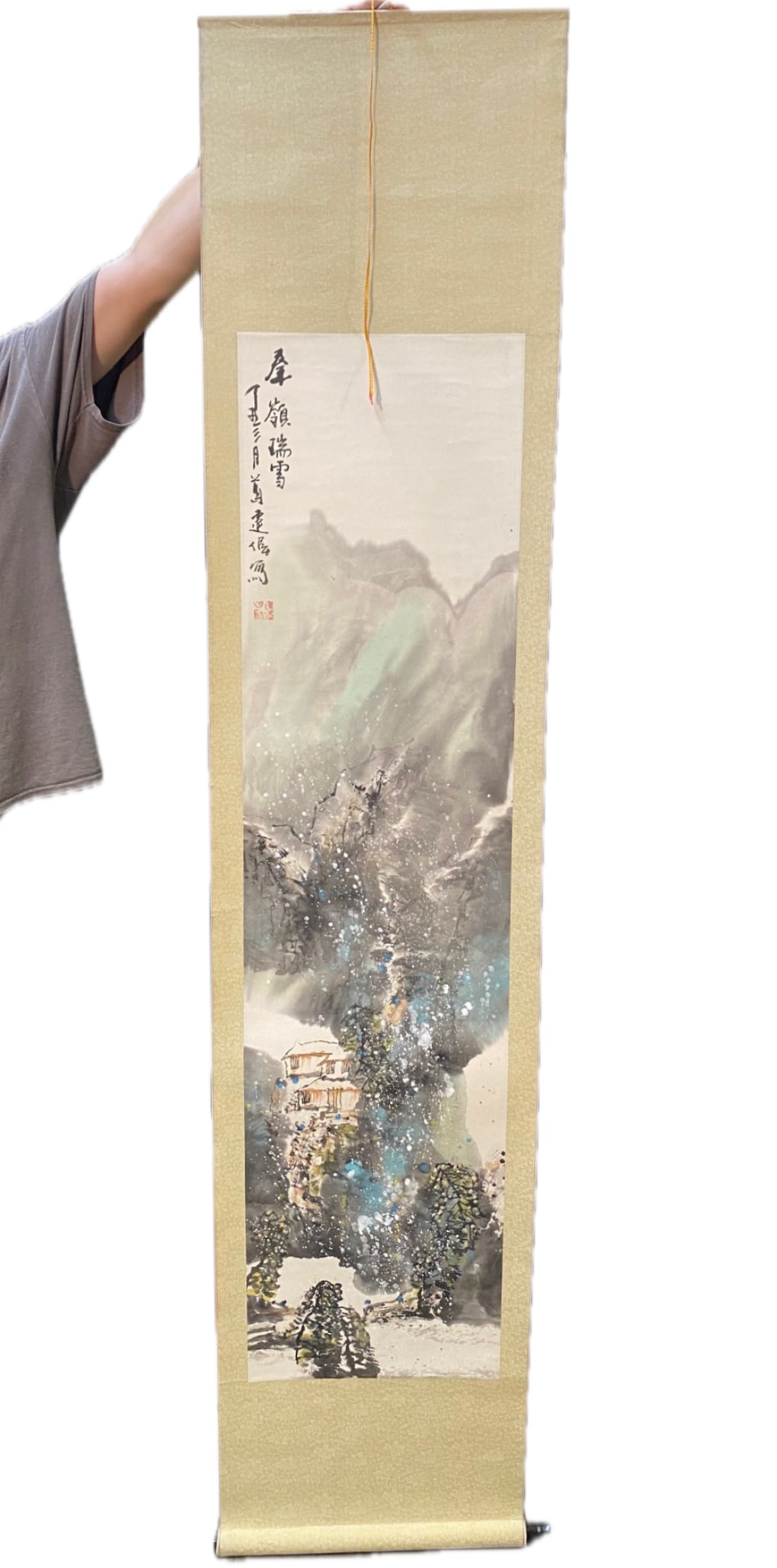 CHINESE SCROLL PAINTING OF THE FIRST SNOW IN THE CHIN MOUNTAINS, 17 IN x 78 IN (43cm x 198cm): A Chinese scroll painting depicting the first snow in the Chin Mountains. A beautiful and colorful painting attached to a silk backing. Signed in the upper left corner. The entire scroll measures 17 i