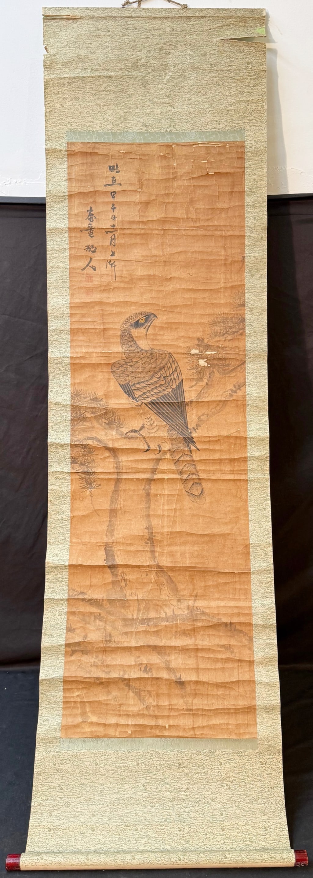 CHINESE SCROLL PAINTING BY TANG DONG, 19TH CENTURY, 21IN x 69IN (53cm x 175cm): A finely executed Chinese literati hanging scroll depicting a hawk perched alertly upon a branch, rendered in ink and restrained color on paper. The hawk is shown in profile with sharpl