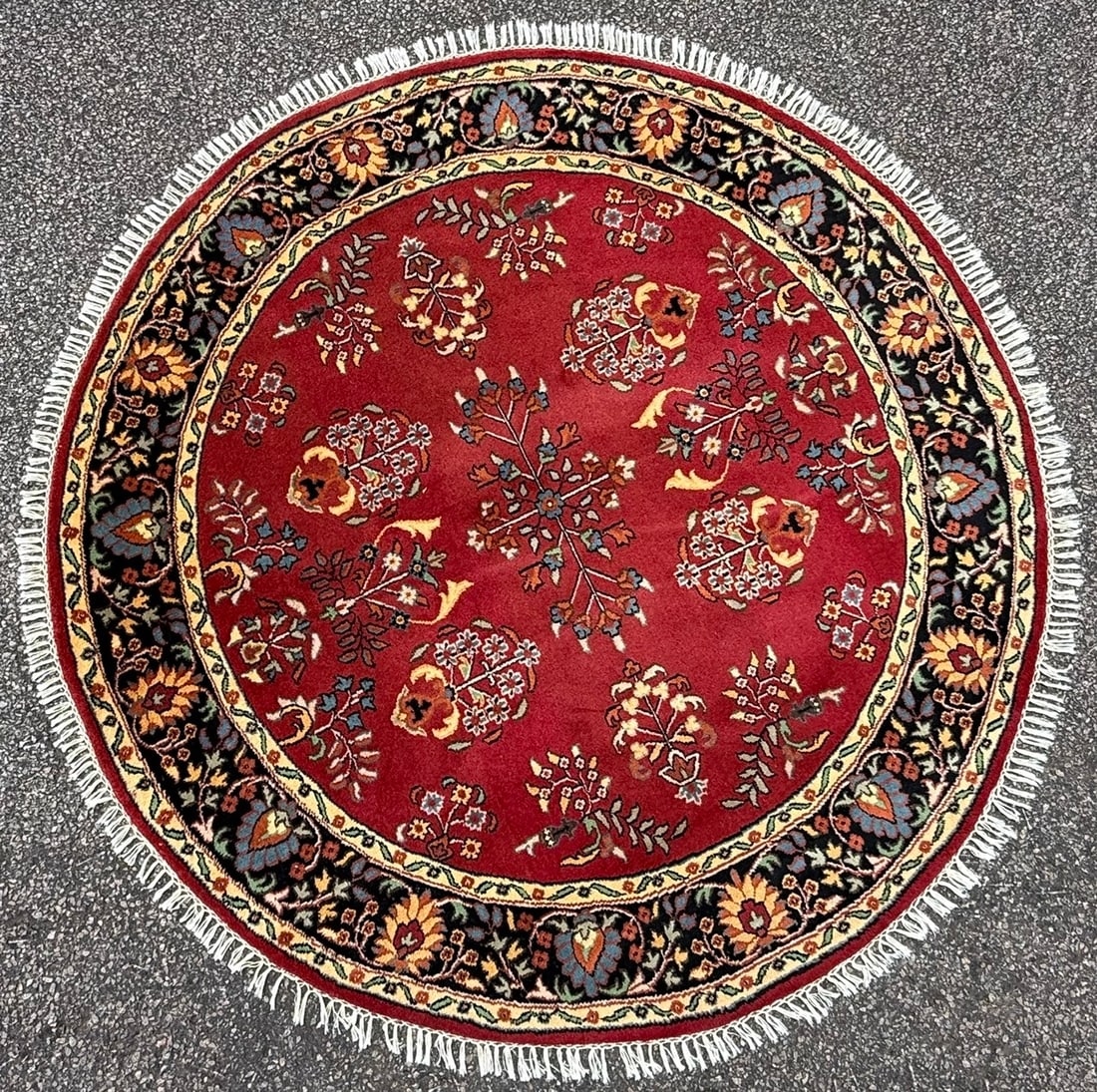 ROUND SAROUK HAND KNOTTED RUG, 6.2 DIAMETER (188cm Diameter): Offered here is a round, Sarouk rug was hand knotted in India of 100 percent natural wool and has a cotton foundation. This rug is 20+ years old and features a vibrant crimson field fra