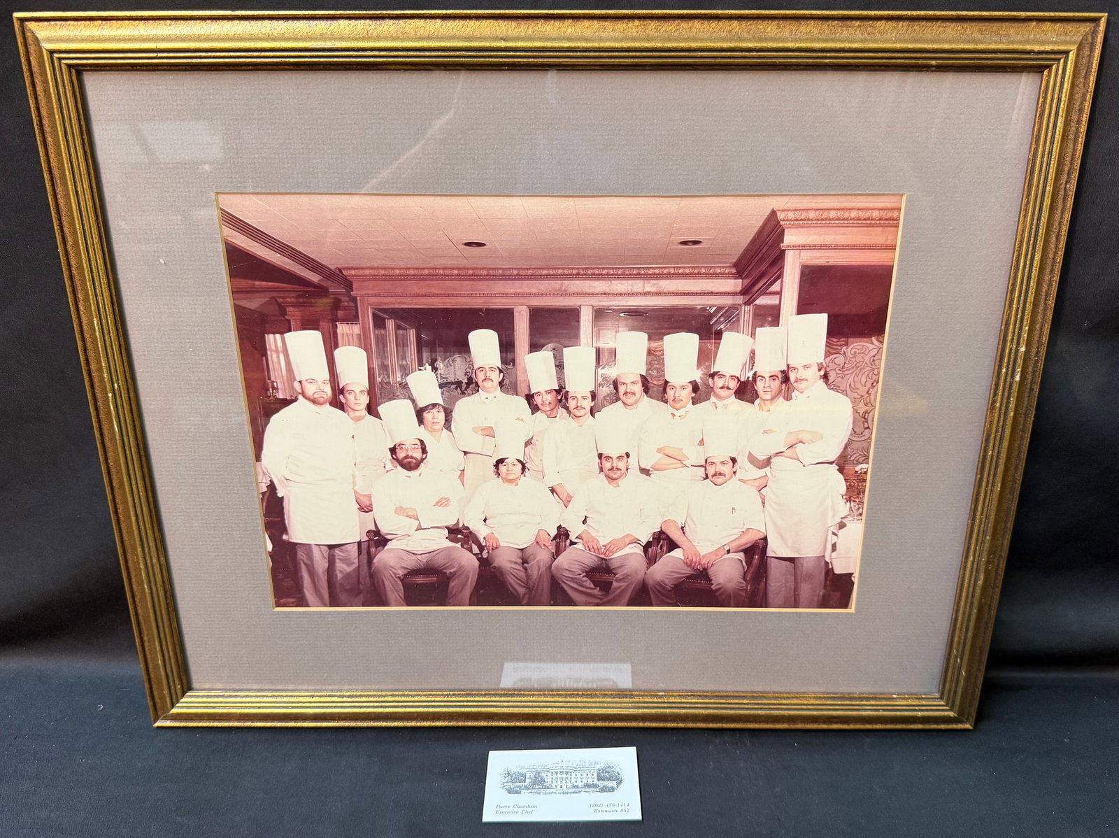 ESTATE OF WHITE HOUSE EXECUTIVE CHEF PIERRE CHAMBRIN, MAISON BLANCHE KITCHEN STAFF PHOTOGRAPH, 16IN: An exceptional and deeply personal framed photograph from the estate of Pierre Chambrin (1947–2024), former Executive Chef of the White House, depicting Chef Chambrin and fellow chefs and kitche