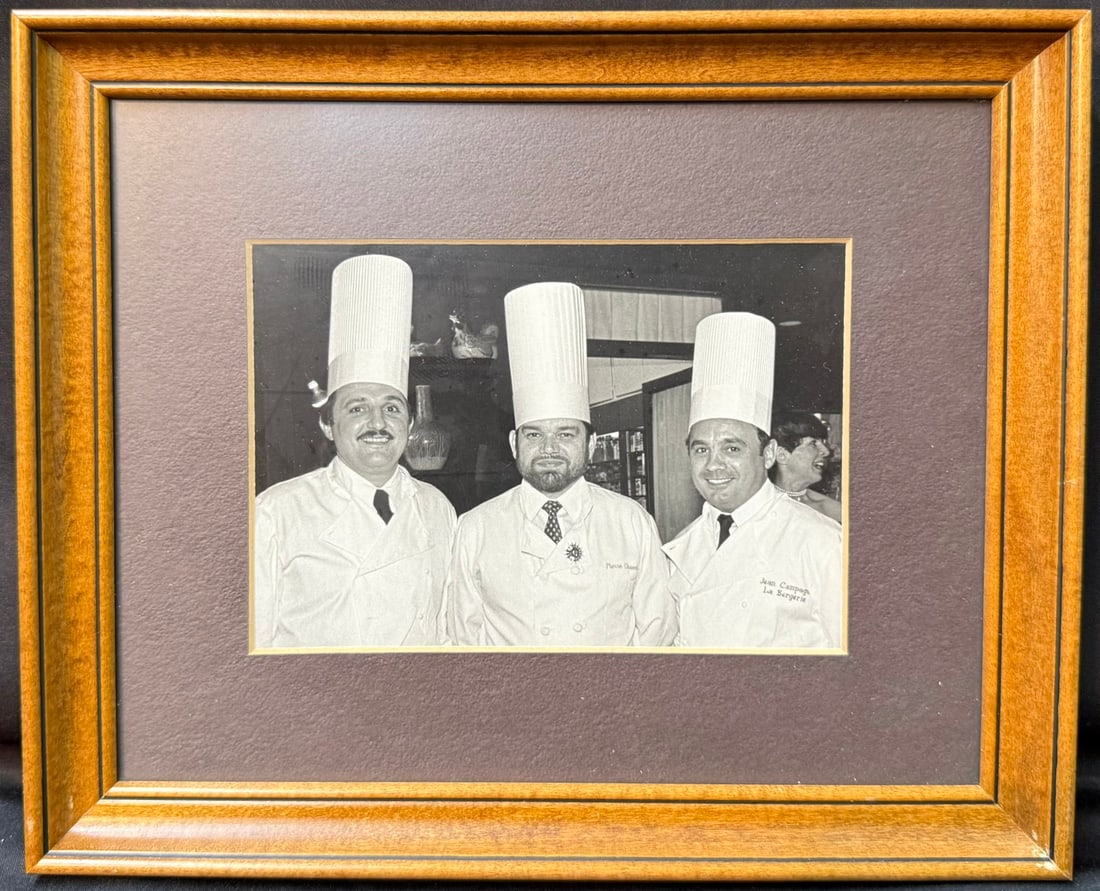 ESTATE OF WHITE HOUSE EXECUTIVE CHEF PIERRE CHAMBRIN, FRAMED PHOTOGRAPH OF PIERRE CHAMBRIN WITH: An exceptional and museum-worthy photograph from the personal estate of Pierre Chambrin (1939–2018), Executive Chef of the White House, depicting Chef Chambrin alongside two of the most respecte