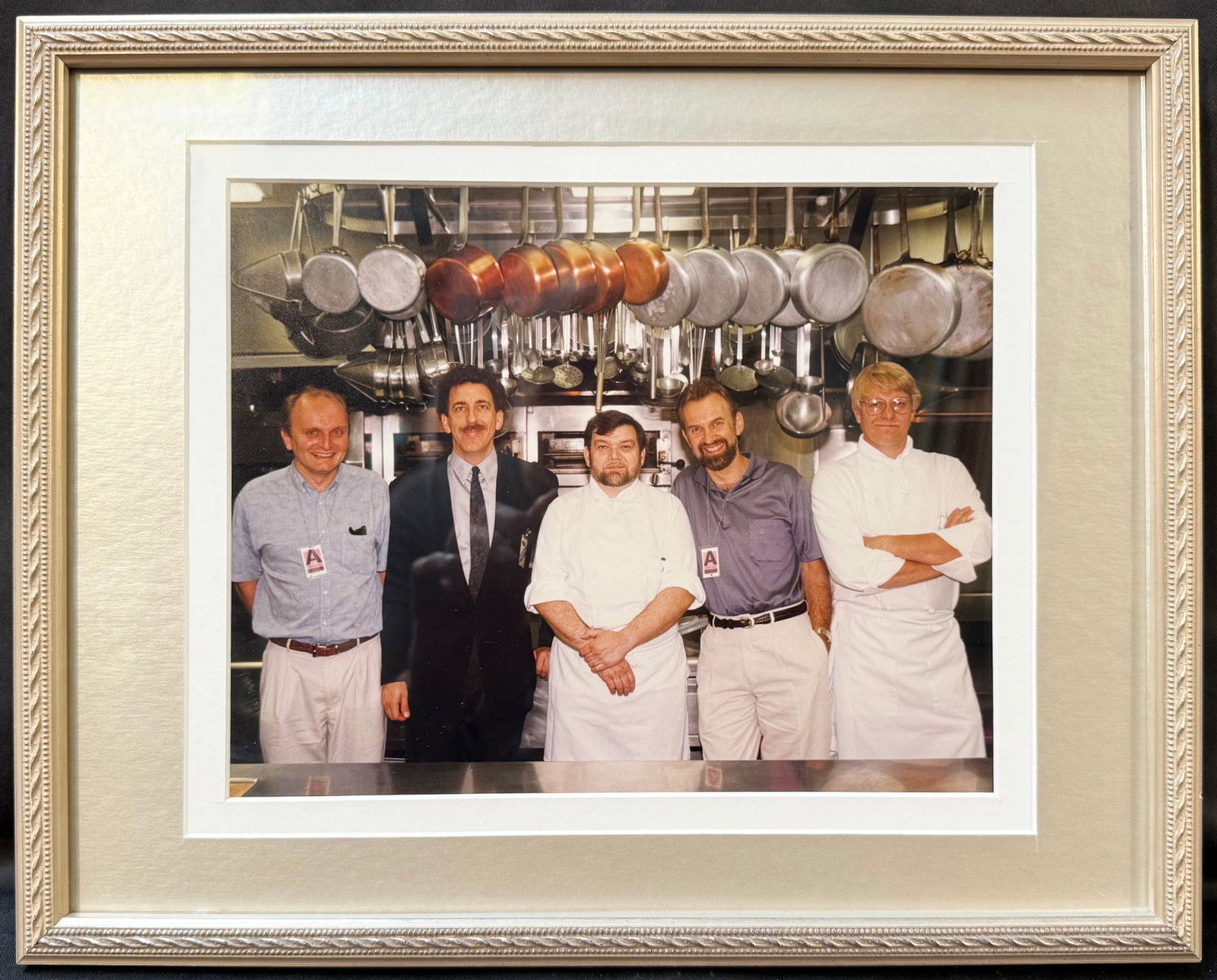 WHITE HOUSE KITCHEN PHOTOGRAPH OF EXECUTIVE CHEF PIERRE CHAMBRIN WITH WHITE HOUSE SOUS CHEF JOHN: A remarkable behind-the-scenes photograph from the private estate of former White House Executive Chef Pierre Chambrin, depicting the Executive Residence kitchen during the Clinton Administration. At 