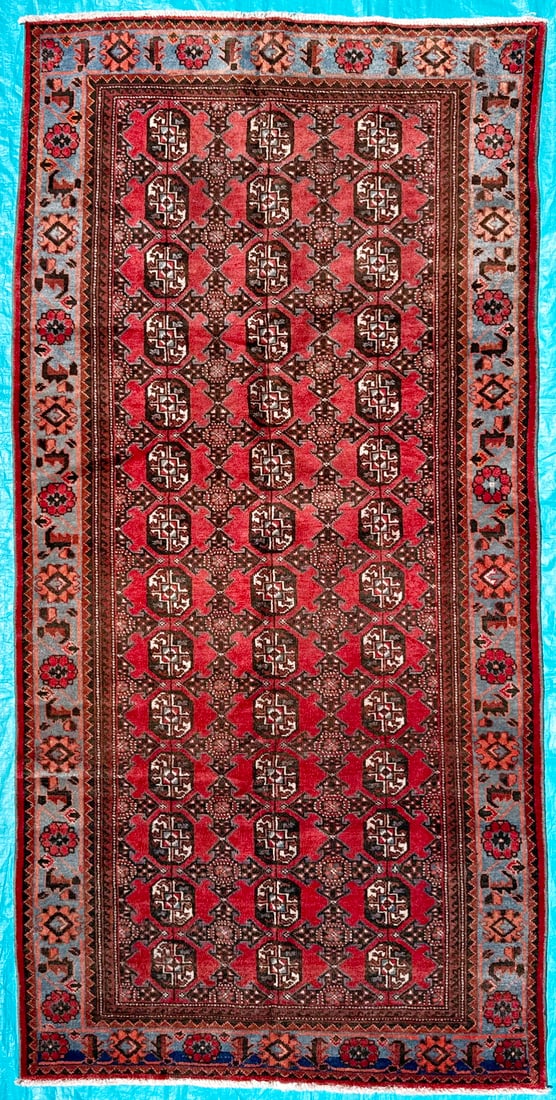 BUKHARA HAND KNOTTED RUG, 4.10 X 9.11 (147cm x 302cm): This Bukhara Tekke rug was hand knotted in Pakistan of 100 percent natural wool on a cotton foundation. This rug is 60 years old has full wool piles and is in excellent condition for its age. Thi