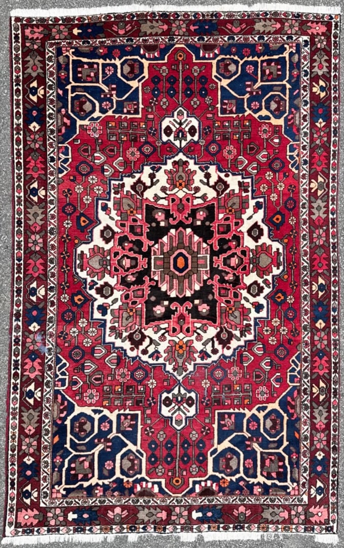 PERSIAN BAKHTIARI HAND KNOTTED RUG, 6.7 x 10.4 (201cm x 315cm): This hand knotted Persian Bakhtiari rug carries the kind of visual weight and cultural depth that defines a truly finished interior. The composition is anchored by a striking ivory-ground central meda