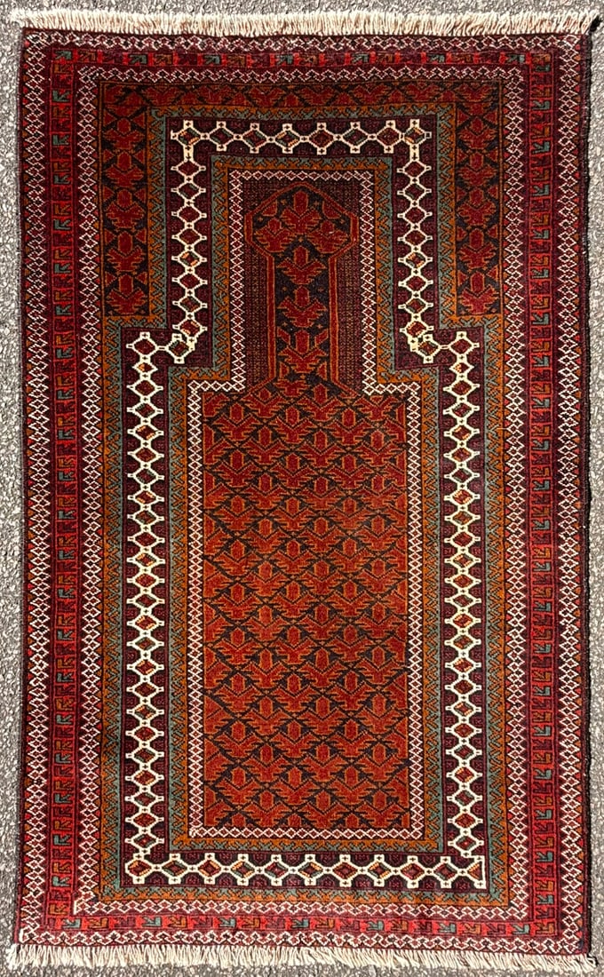 AFGHANI BALOUCH HAND KNOTTED TRIBAL RUG, MOODY OXBLOOD AND ESPRESSO PALETTE, 2.10 x 4.9 (86cm x: A striking hand-knotted Balouch tribal prayer rug distinguished by its rich jewel-toned palette, architectural design, and highly collectible nomadic character. Woven by Baluch tribal artisans and ret