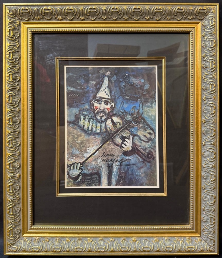 MARC CHAGALL (1887-1985) HAND SIGNED LITHOGRAPH TITLED LE CLOWN MUSCIEN, 18IN x 21IN (46cm x 53cm): Marc Chagall (1887-1985) hand signed lithograph titled Le Clown Muscien. This piece is after the original which was painted in 1927. This piece was produced in 1977 in Paris, France and it is hand sig