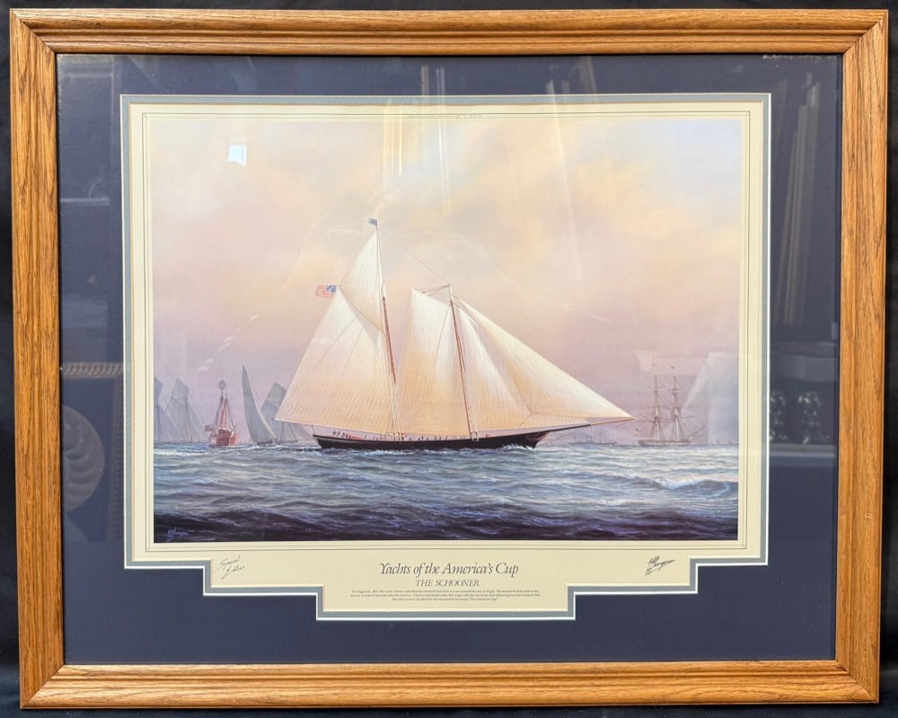 YACHTS OF THE AMERICA?S CUP, THE SCHOONER FRAMED MARITIME ARTWORK, 25IN x 31IN (64cm x 79cm): A striking and elegantly composed maritime artwork titled “Yachts of the America’s Cup – The Schooner,” capturing the legendary yacht America during her historic 1851 victory&#