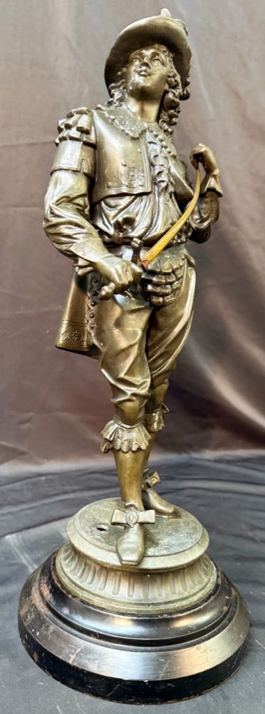 FRENCH SPELTER FIGURE ON TURNED WOODEN BASE, LATE 19th CENTURY, 20IN x 9IN x 9IN (51cm x 23cm x: This finely cast late 19th-century French decorative sculpture depicts a gallant 17th-century Cavalier, dressed in full courtly attire and rendered with remarkable elegance and theatrical charm. 
