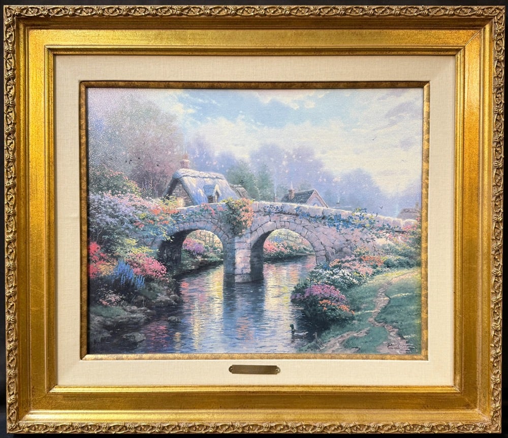 THOMAS KINKADE (1958-2012) LIMITED EDITION, HAND HIGHLIGHTED LITHOGRAPH ON CANVAS TITLED BLOSSOM: A luminous and idyllic composition by America’s celebrated Painter of Light, Thomas Kinkade, Blossom Bridge is the inaugural work in the artist’s Blossom Lane seri