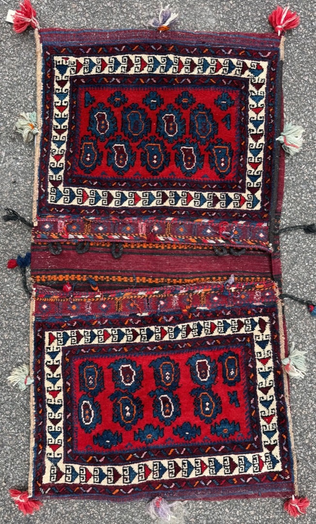 VINTAGE PERSIAN TRIBAL KHORJIN SADDLE BAG, HANDWOVEN NOMADIC DOUBLE-POUCH, 2.6 x 4.9 (76cm x 145cm): A traditional Persian tribal double saddlebag (khorjin), hand-woven in wool by nomadic weavers of western or southern Iran, likely Afshar or Qashqai tribal origin, mid-20th century. The piece retains 