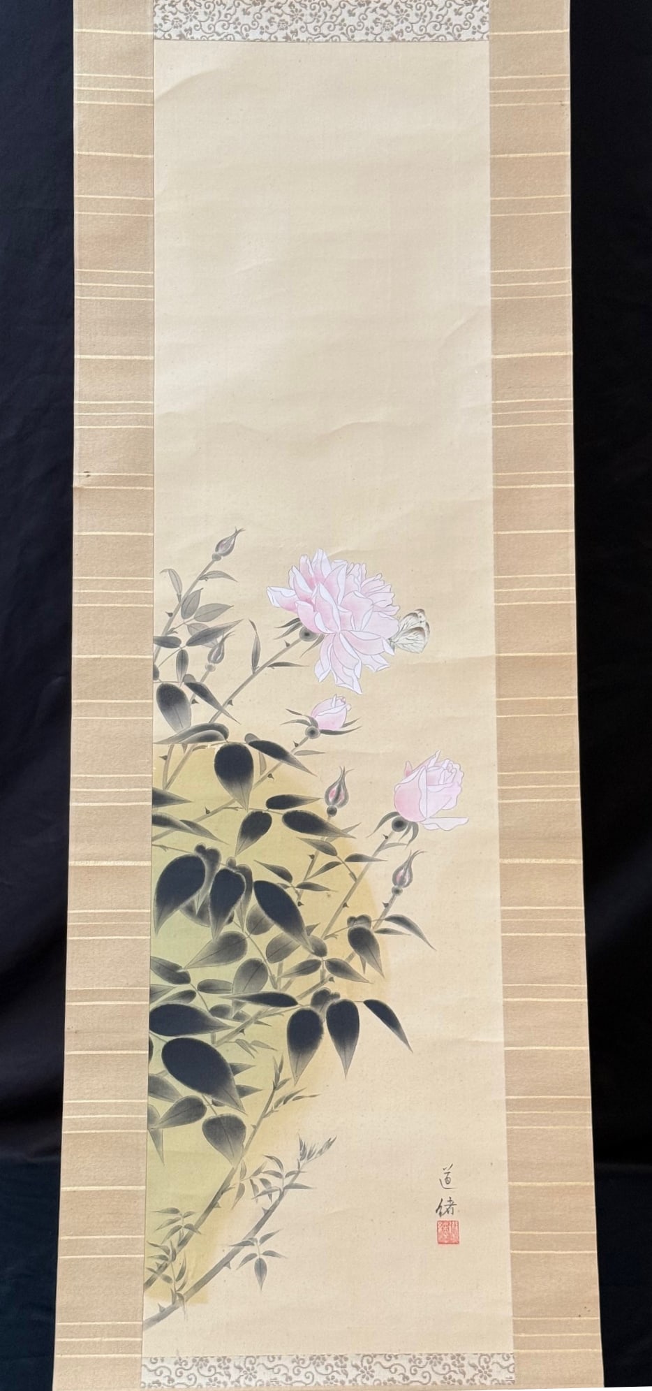 ANTIQUE JAPANESE INK AND COLOR HANGING SCROLL OF PEONIES AND BUTTERFLY, 18IN x 76IN (46cm x 193cm): A refined Japanese hanging scroll depicting blossoming peonies accompanied by a delicately rendered butterfly, painted in ink and soft mineral pigments on silk. The composition emphasizes eleganc