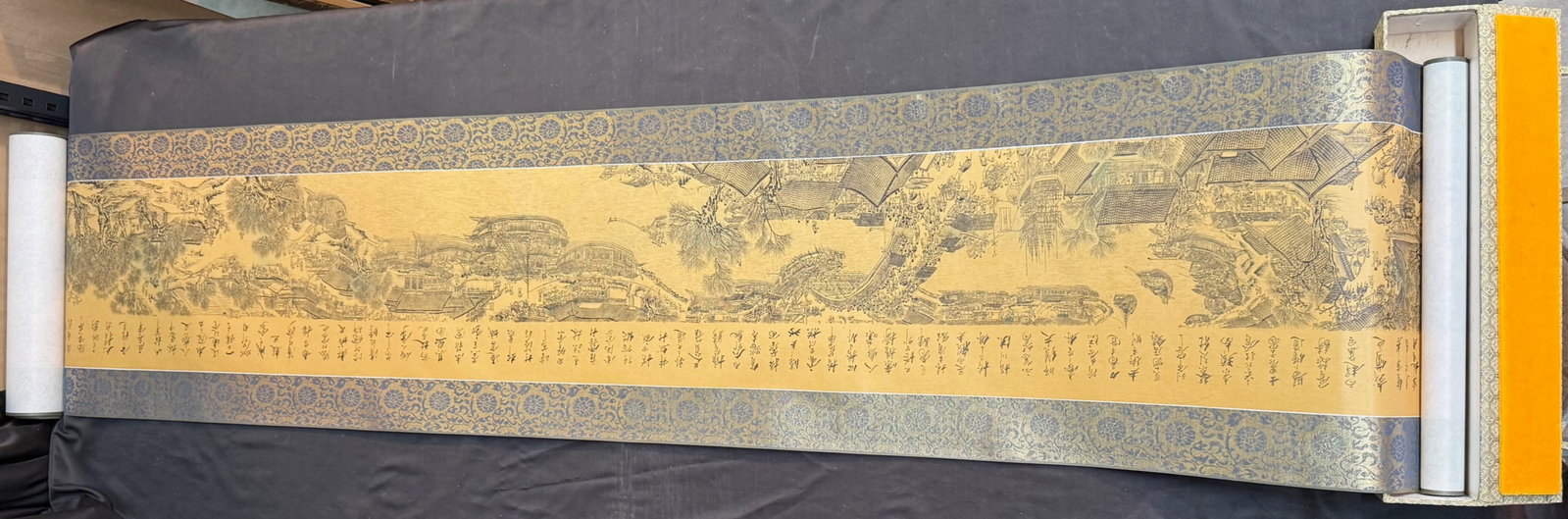 CHINESE SCROLL TITLED ALONG THE RIVER DURING THE QINGMING FESTIVAL, 16IN x 159IN (41cm x 404cm): A Chinese scroll painting titled Along the River During the Qingming Festival. This piece is after the original which first produced between 1085-1145, and is attributed to Zhang Zeduan. This is 