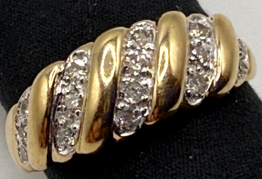 10K YELLOW GOLD AND DIAMOND DOME RING: One 10k yellow gold diamond dome ring. Mounted in this ring are sixteen round cut diamonds. These diamonds have an approximate total diamond weight of 20cts, color I and a clarity of I1. This ring has