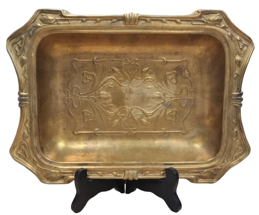 An antique art nouveau dish made of brass some dents to the outer rim, width 23 cm, length 32 cm: An antique art nouveau dish made of brass some dents to the outer rim, width 23 cm, length 32 cm