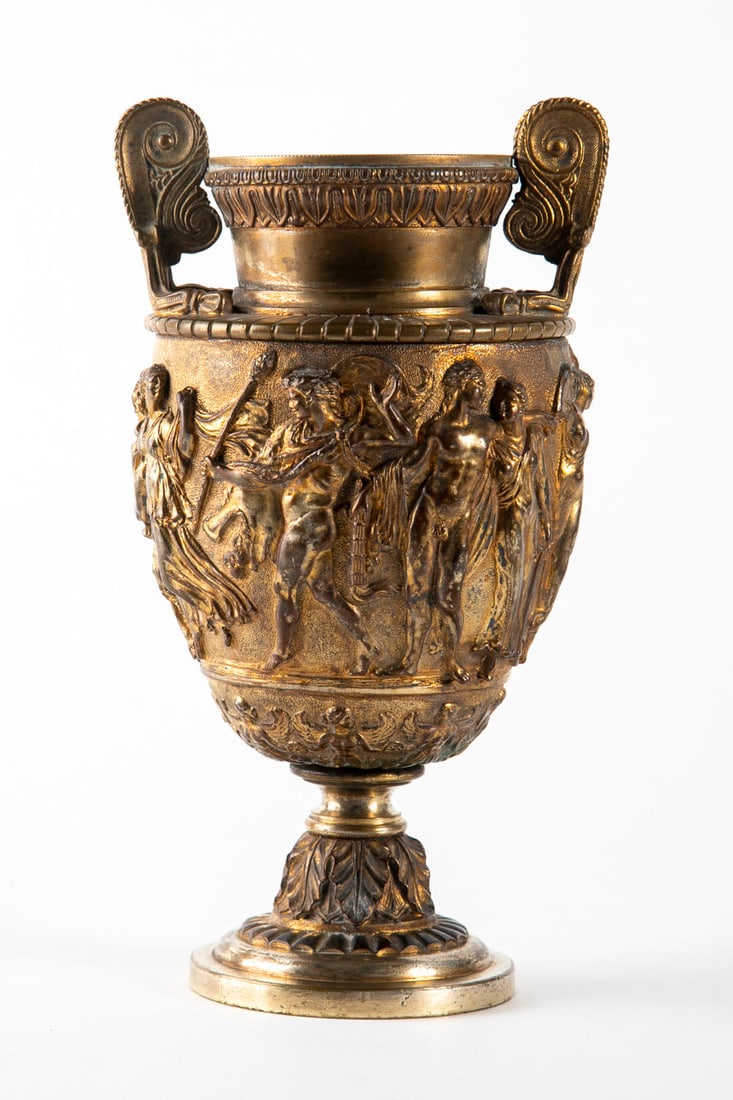 A Fine Cast Bronze "Townley" Urn, England, ca 1870-1890: Height: 21.5 cm; width: 12 cm The Townley Urn is a 2nd century BCE Roman marble urn discovered by the neo-classical painter and art dealer Gavin Hamilton.The intricate urn relief describes detailed b